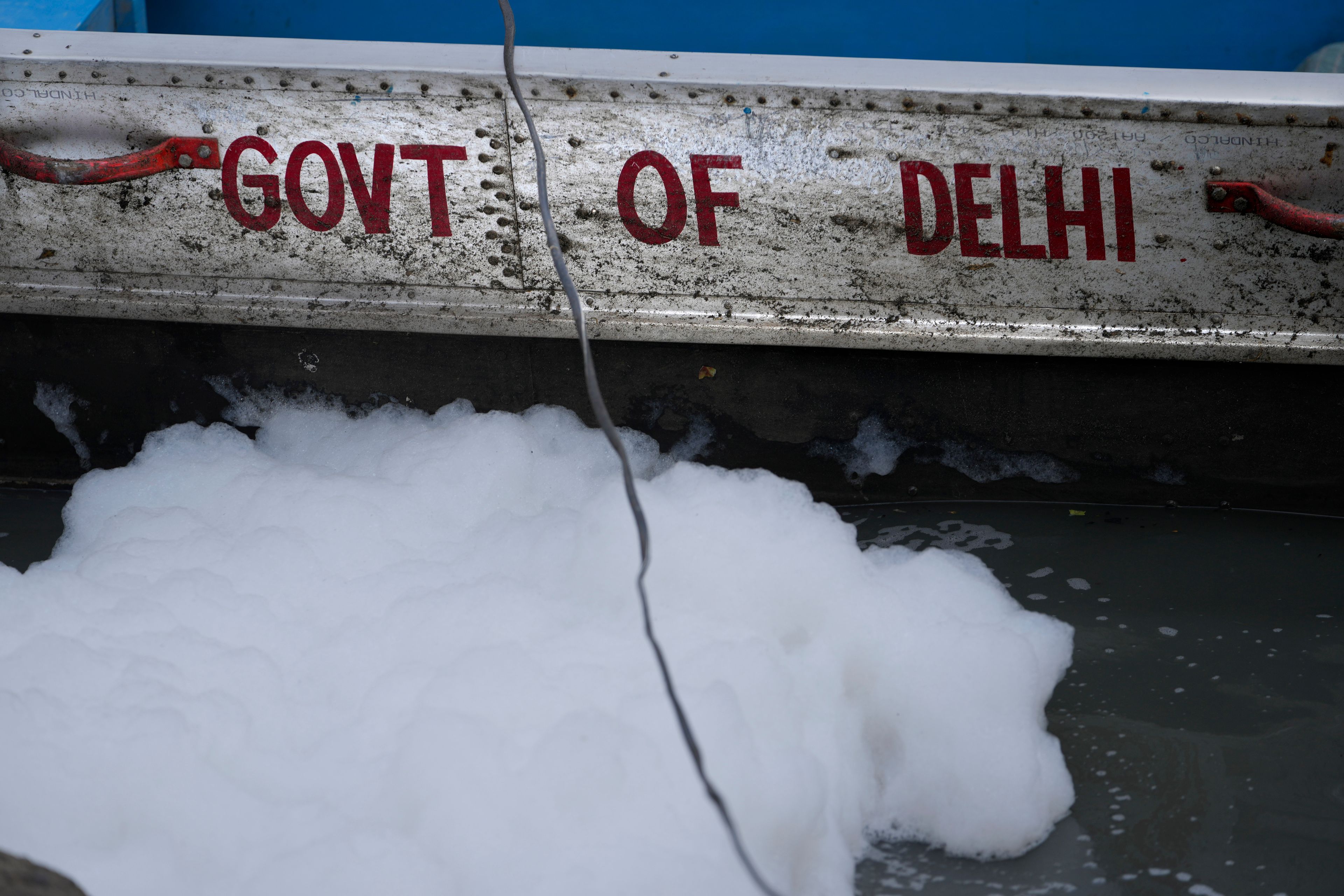 Toxic foam floats near the boat of the Delhi Jal or water board in the river Yamuna in New Delhi, India, Tuesday, Oct. 29, 2024. (AP Photo/Manish Swarup)