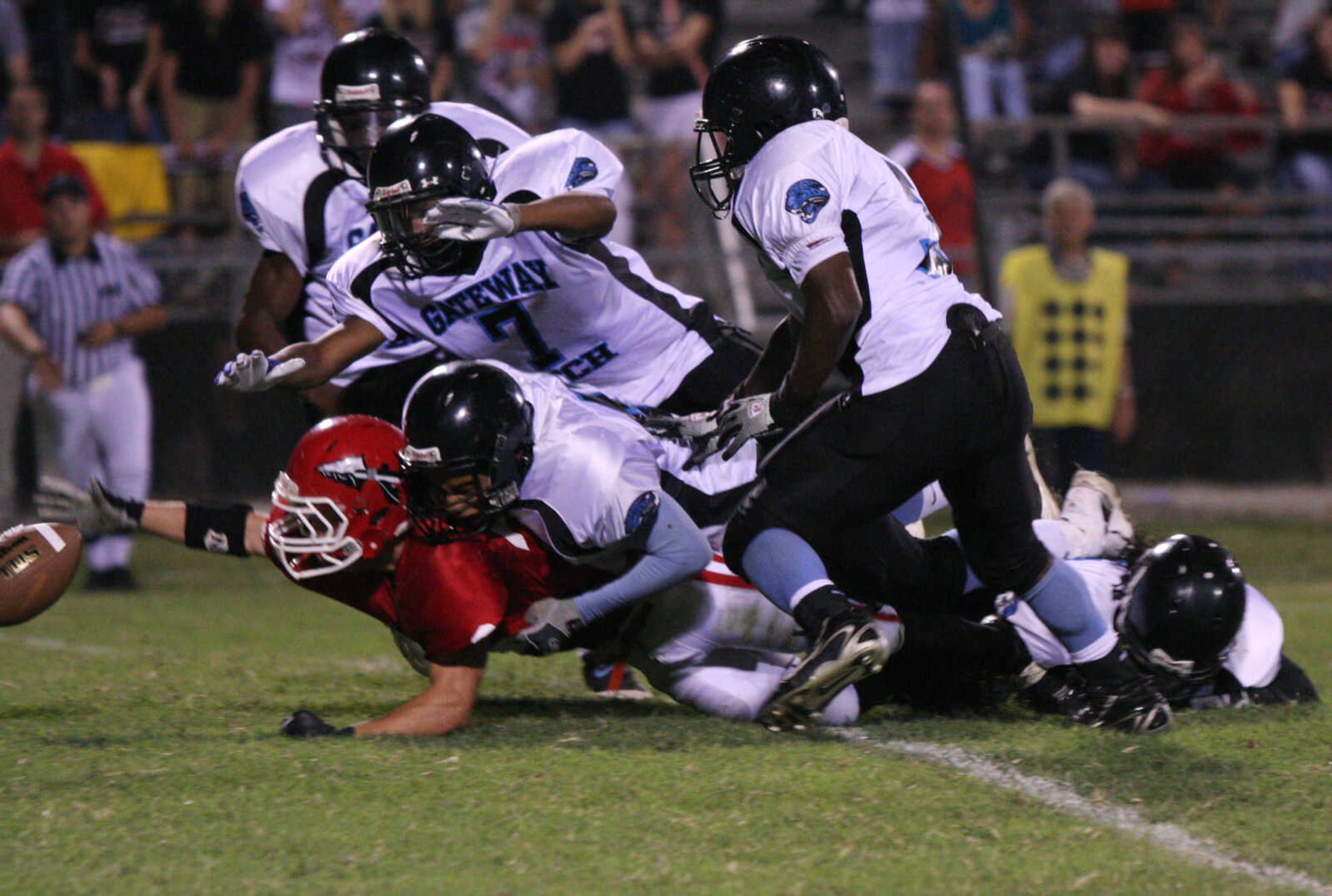 Jackson's Stetson Proffer is overwhelmed by Gateway Tech defenders, nearly costing Jackson possession of the ball.