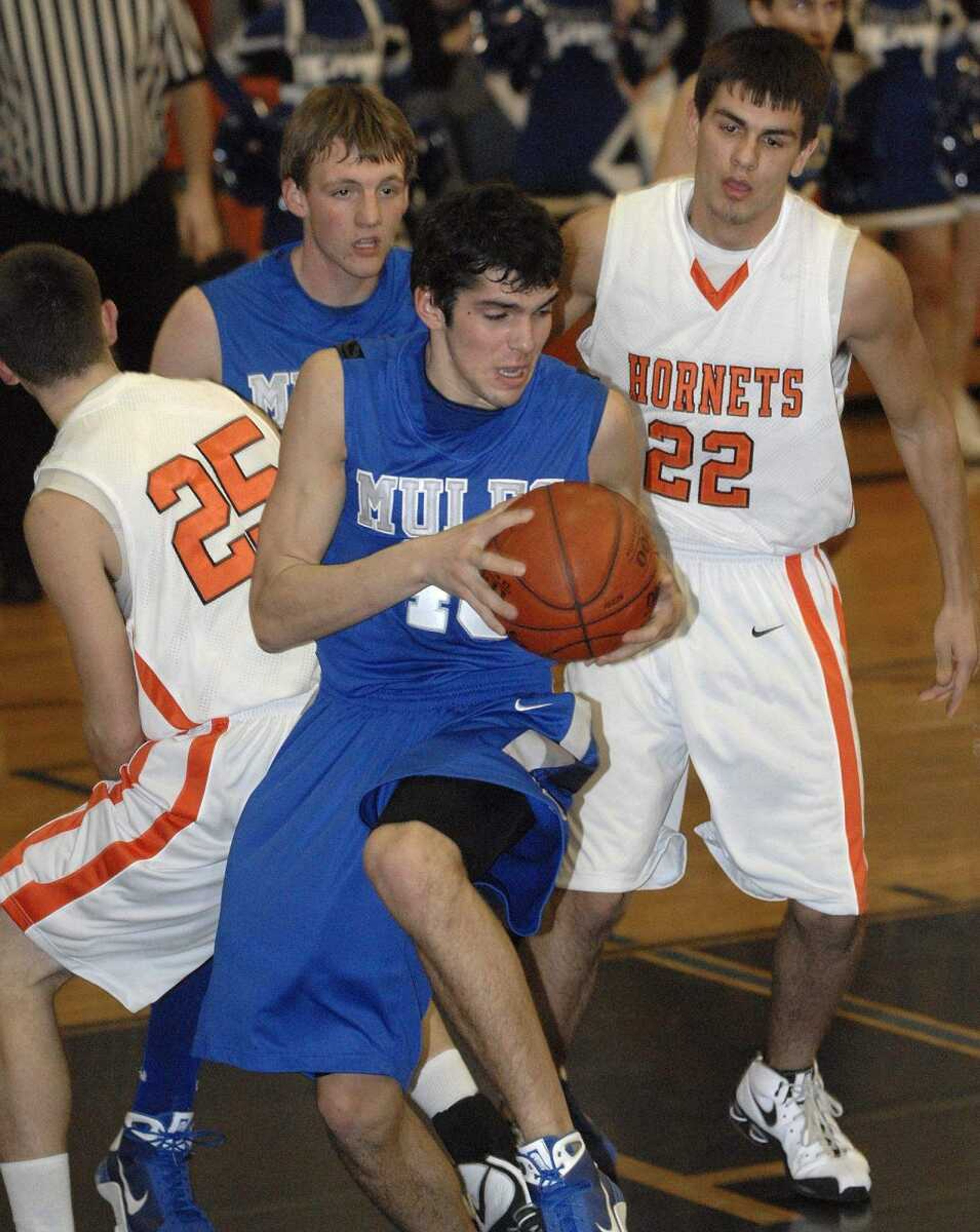 FRED LYNCH ~ flynch@semissourian.com
Bernie's Daniel Becking pulls down a rebound between Advance's Cody VanGennip and David VanGennip in the first quarter Friday at Advance.