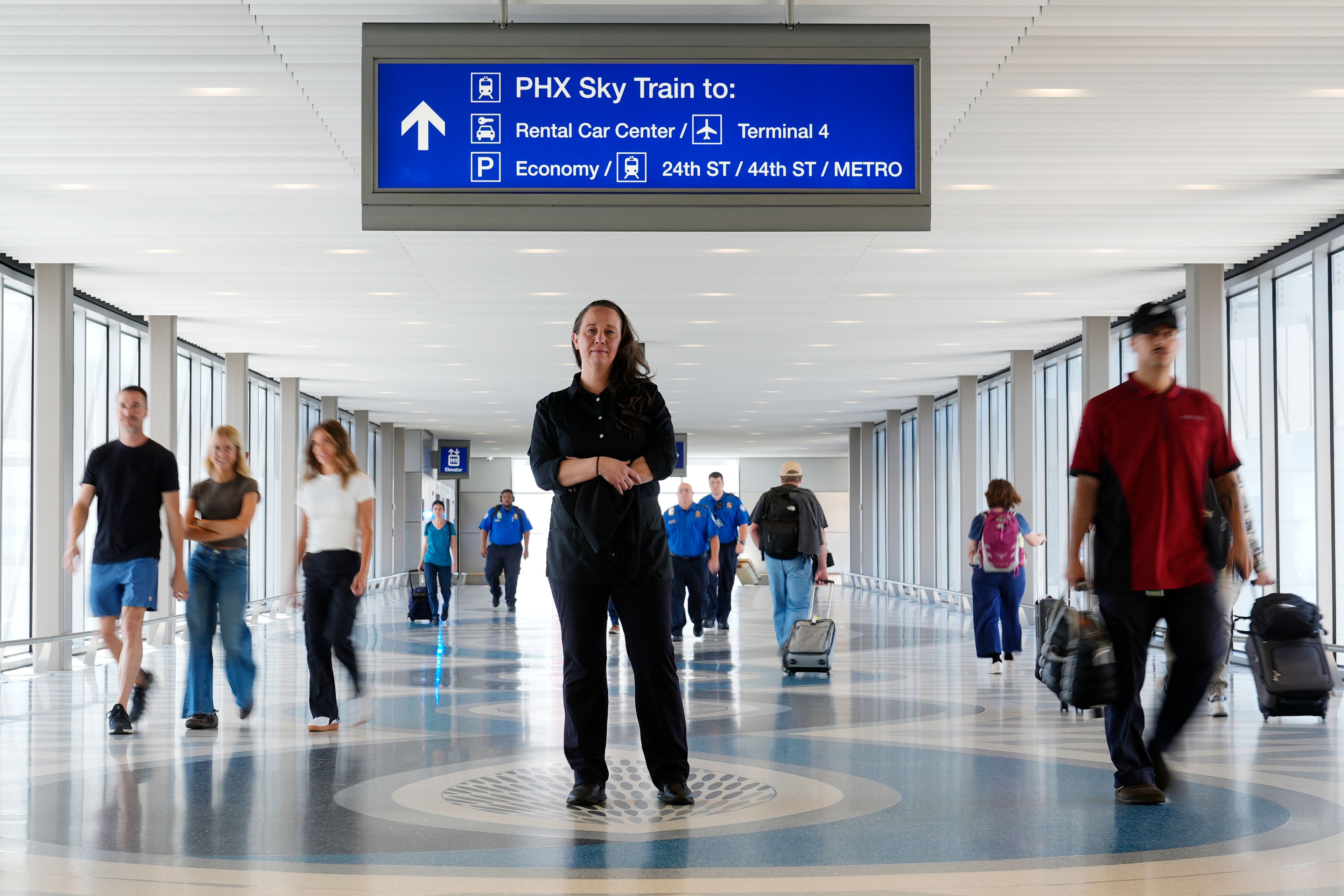 Lindsay Ruck, a server at Phoenix Sky Harbor International Airport restaurants, pauses in Terminal 3 as she is anticipates the vote on Arizona Prop 138 on minimum wage Thursday, Oct. 3, 2024, in Phoenix. (AP Photo/Ross D. Franklin)