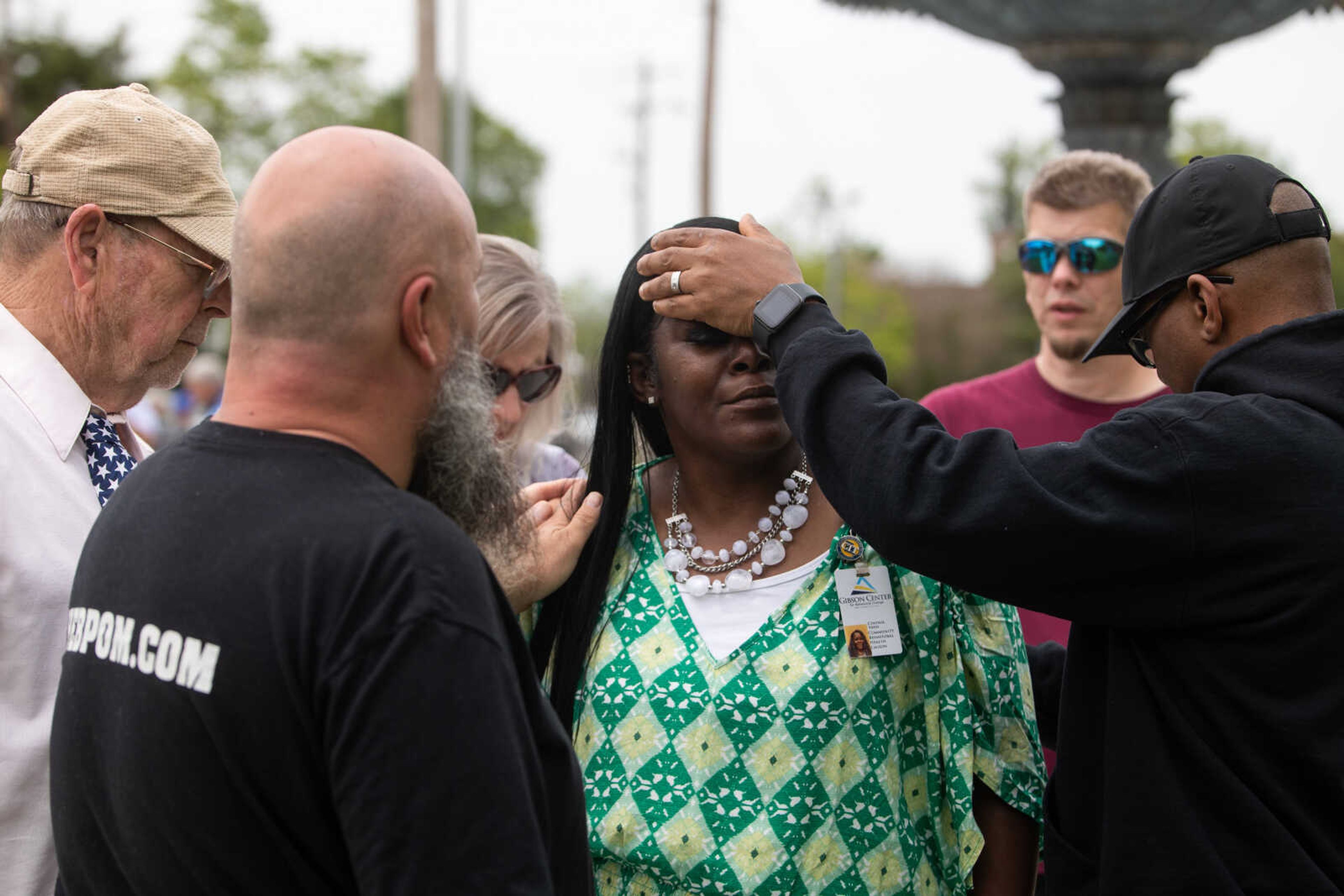 Cynthia Vann is prayed over by pastor Benjamin Porter, right, evangelist James Rowe, left, and community members on the National Day of Prayer on Thursday, May 4 at Cape Girardeau City Hall.