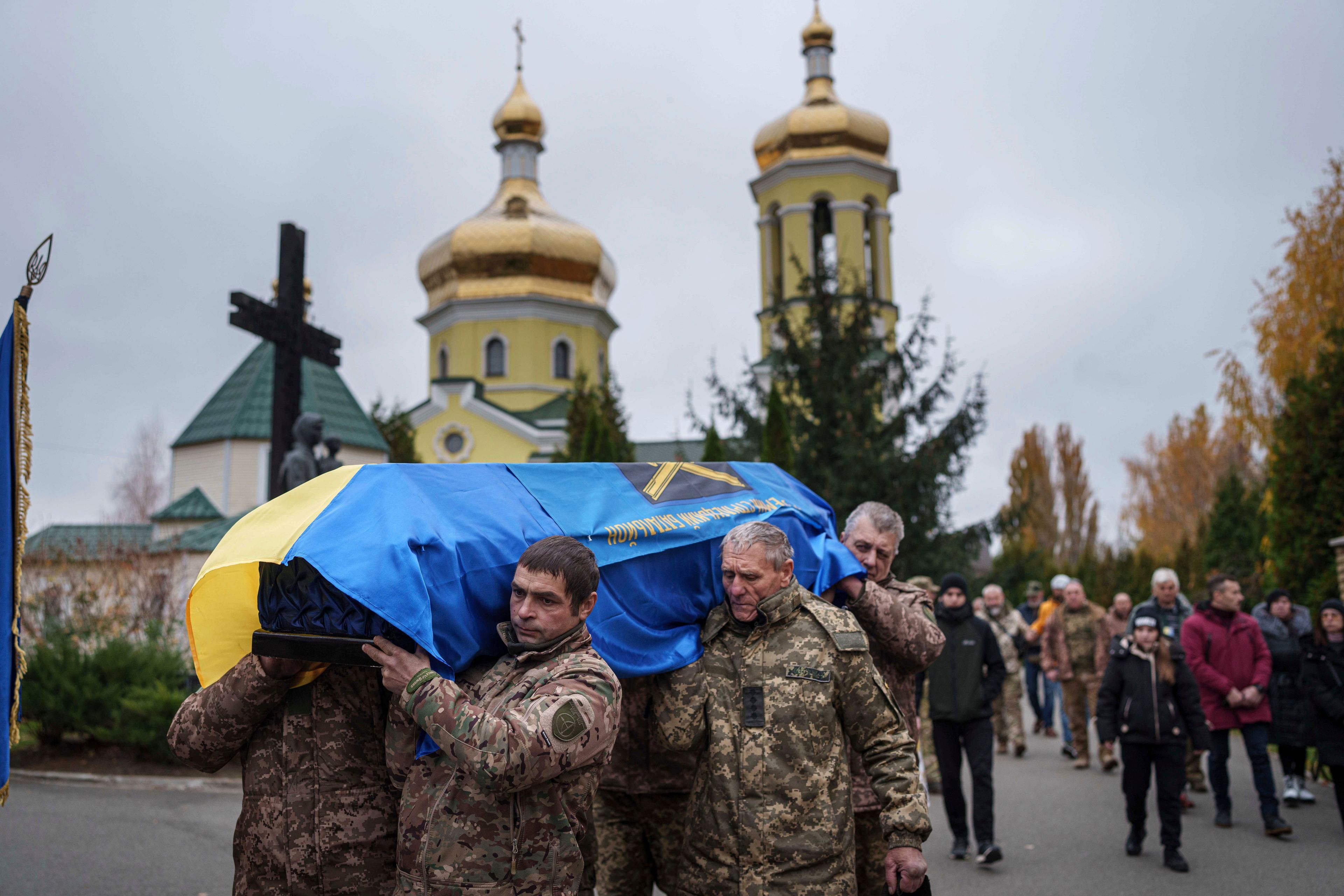 Members of the honor guard carry the coffin of Yurii Moiseev, a Ukrainian soldier of the 44th Battalion who was killed during fighting with Russian forces in Terny on Nov. 28, 2023, during the funeral ceremony in Brovary, Kyiv region, Ukraine, Nov. 11, 2024. (AP Photo/Evgeniy Maloletka)