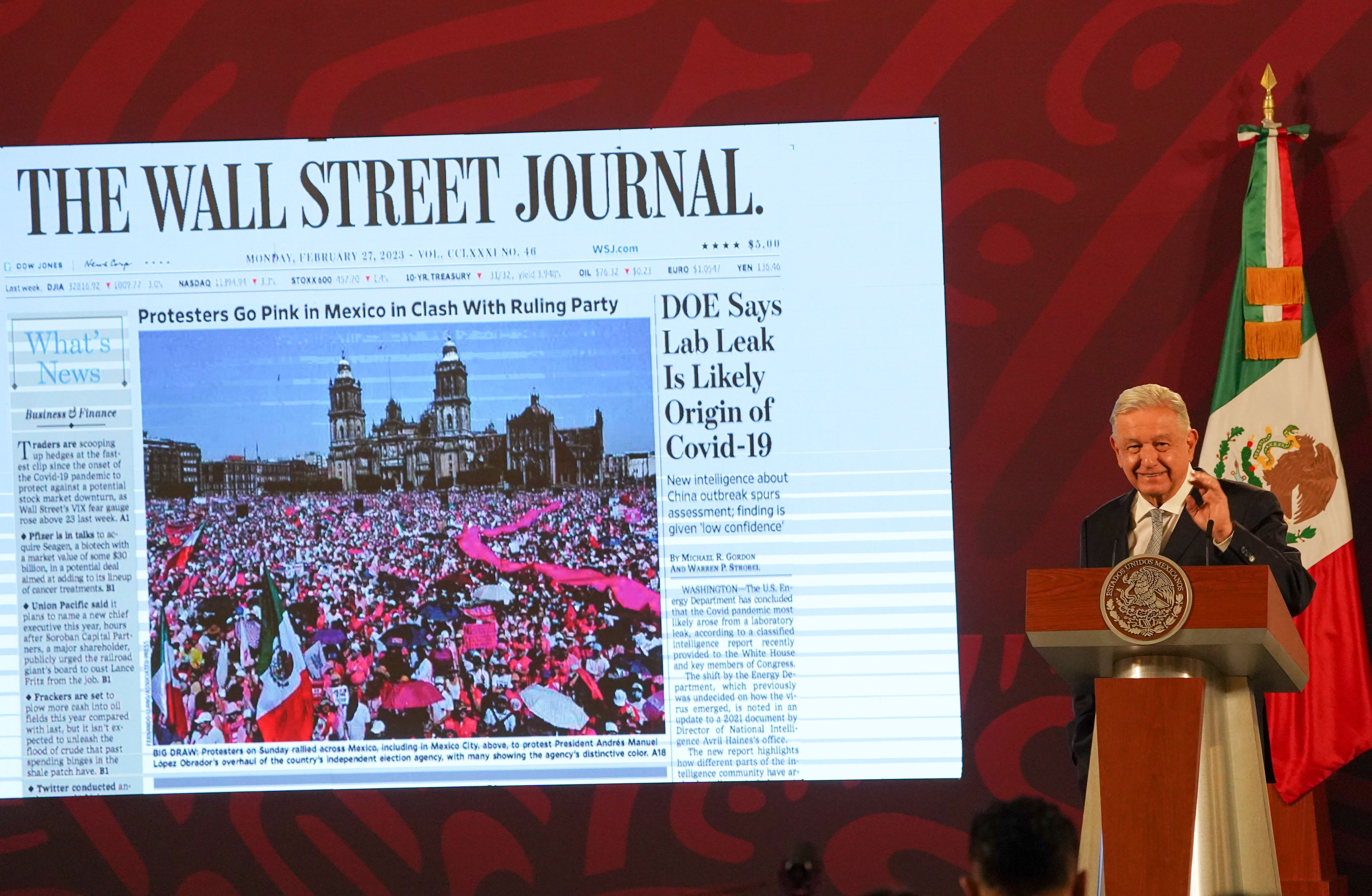 FILE - Mexican President Andres Manuel Lopez Obrador shows the front page of The Wall Street Journal, featuring a story about opposition to his electoral law changes, during his regularly scheduled morning press conference at the National Palace in Mexico City, Feb. 28, 2023. (AP Photo/Marco Ugarte, File)