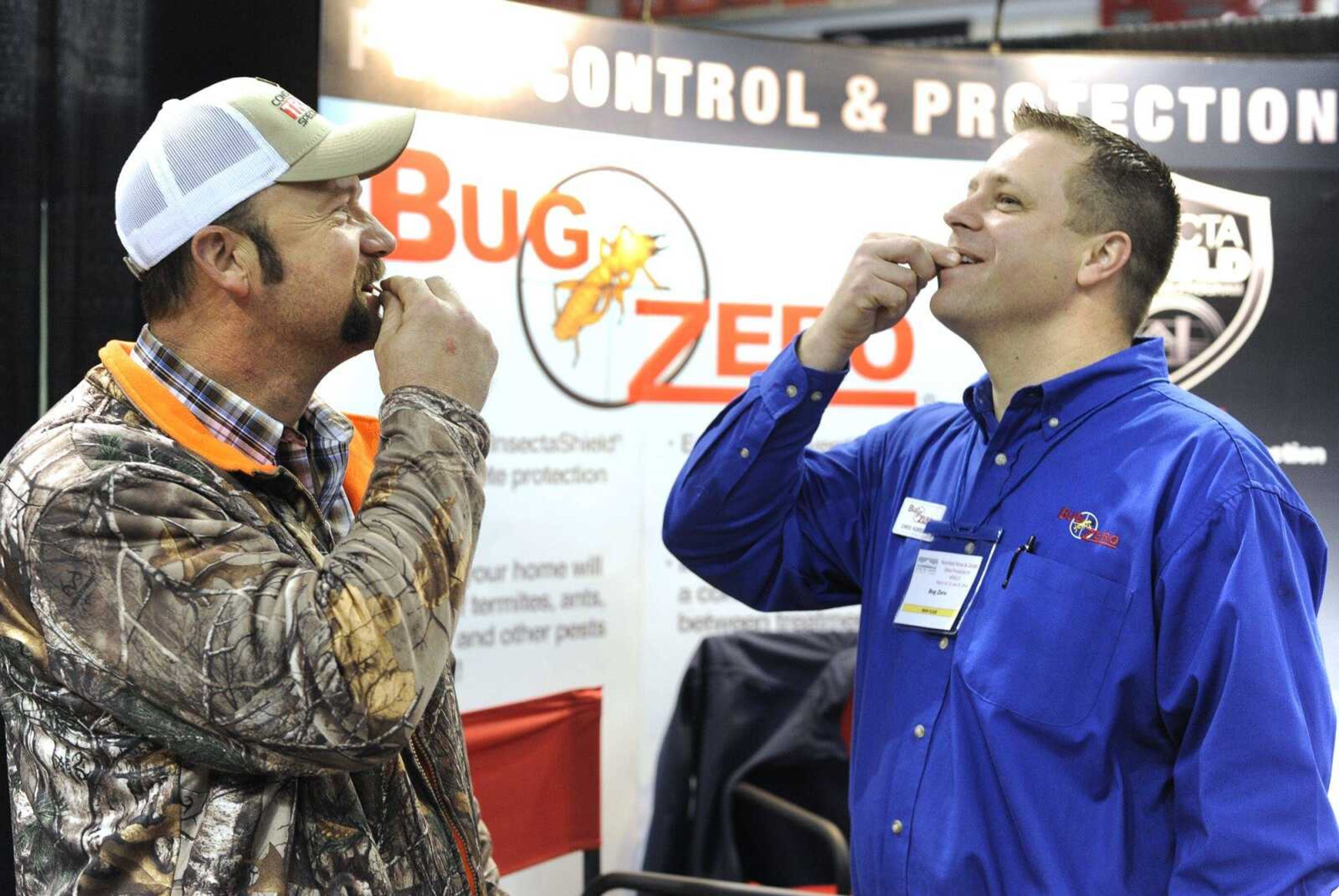 Patrick Nenninger, left, of Advance, Missouri, accepts a challenge by Chris Horrell to eat a bug at the Bug Zero exhibit of the Heartland Home and Garden Show on Saturday at the Show Me Center. Nenninger chose a Mexican-spice larva, and Horrell preferred a bacon-and-cheese cricket. More photos from the home show are in a gallery at semissourian.com.