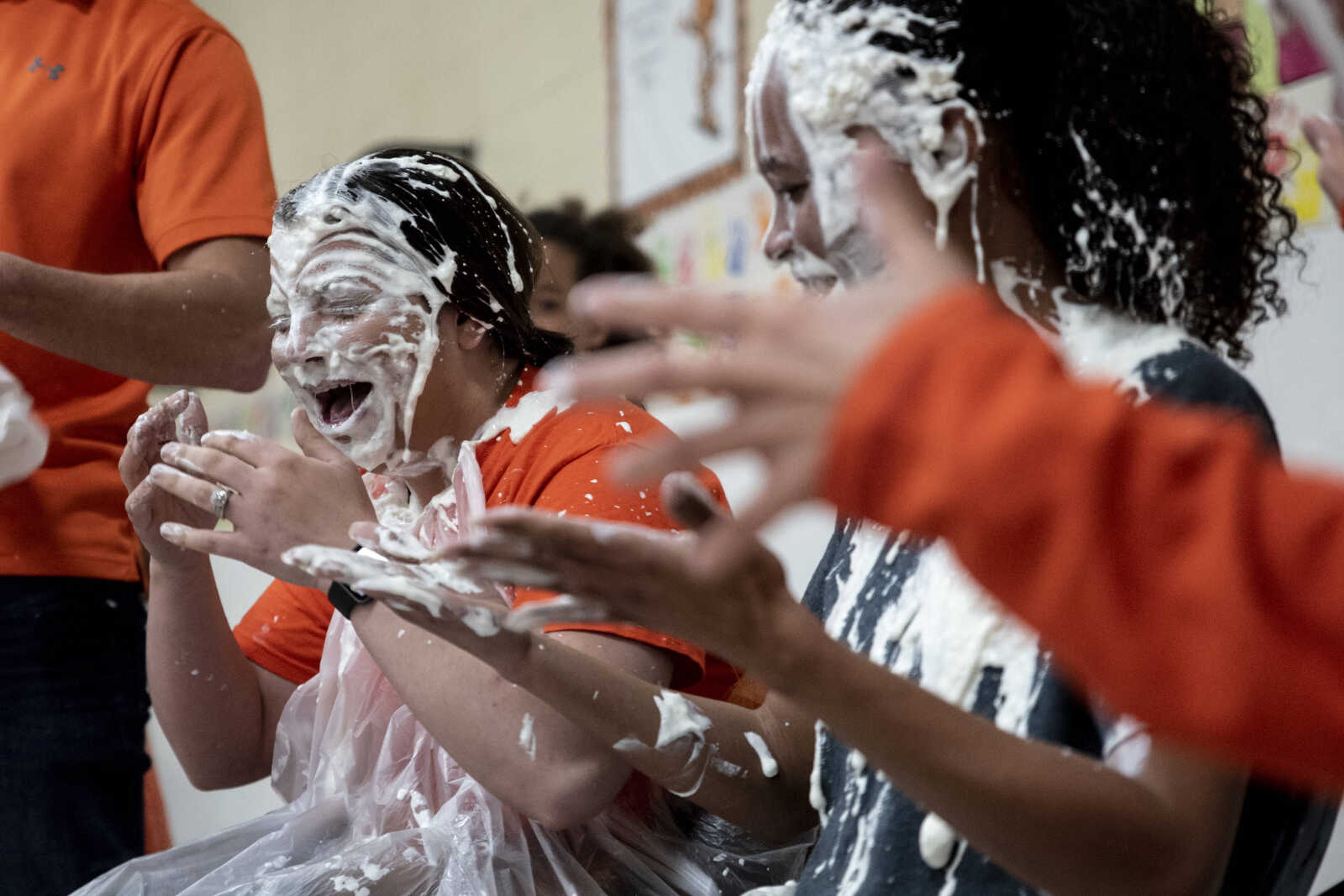 Samantha Rose reacts with colleagues Charity Owens and Amy Emmenderfer after being pied in the face by students at Clippard Elementary School Friday, April 5, 2019, in Cape Girardeau. Students earned votes for which teacher(s) would get pied in the face when they brought in donations to raise money for their end-of-the-year play day that is free to students. Through students and other donations, the school raised $550 towards their play day activities.