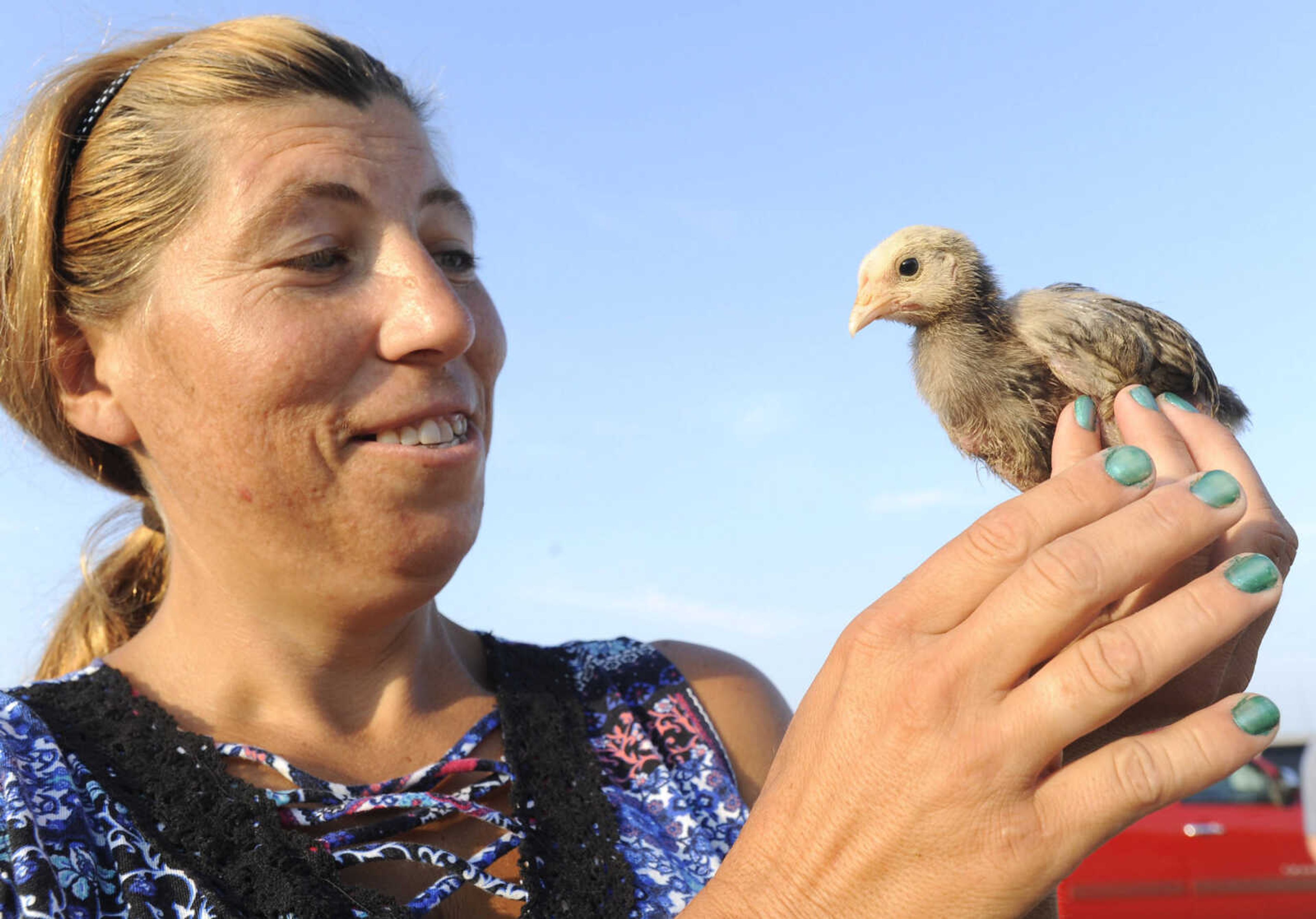 FRED LYNCH ~ flynch@semissourian.com
Crista Meyer shows the chick she bought for a dollar Saturday, July 14, 2018 at the Fruitland Swap Meet in Fruitland.