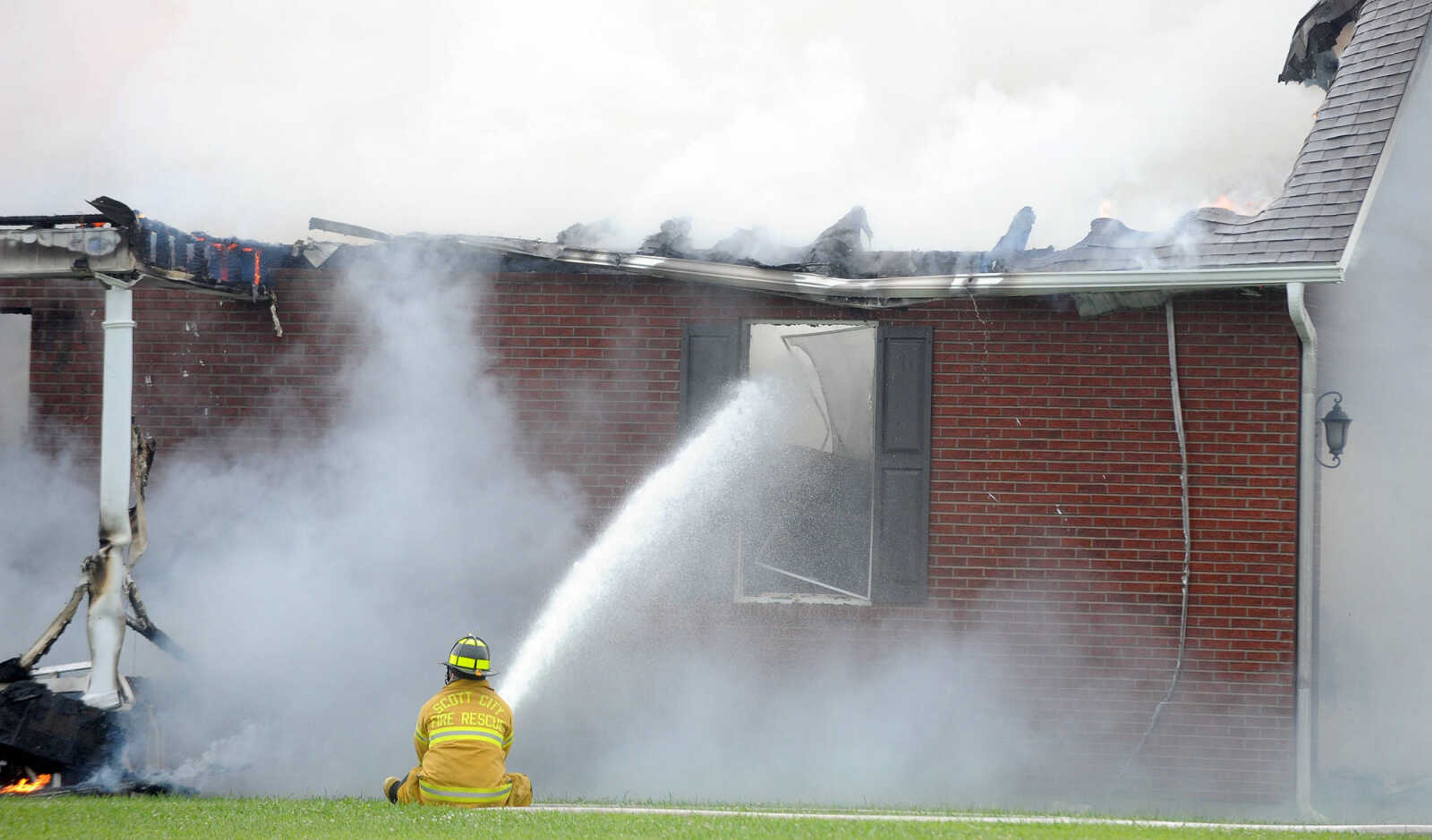 LAURA SIMON ~ lsimon@semissourian.com

Firefighters from Delta, Scott City, Chaffee and New Hamburg/Benton/Commerce battle a house fire off County Road 204 in Scott County Wednesday afternoon, July 23, 2014.