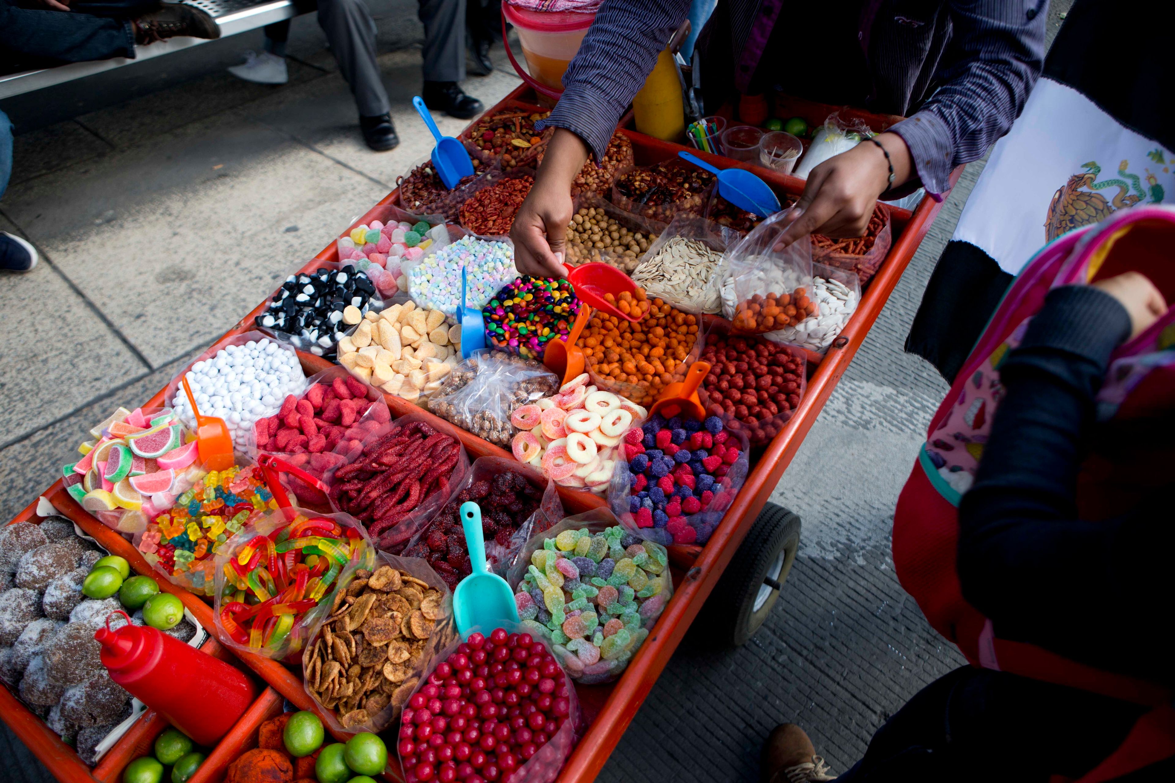 FILE - A street vendor sells sweet snacks in Mexico City, July 5, 2016. (AP Photo/Eduardo Verdugo, File)