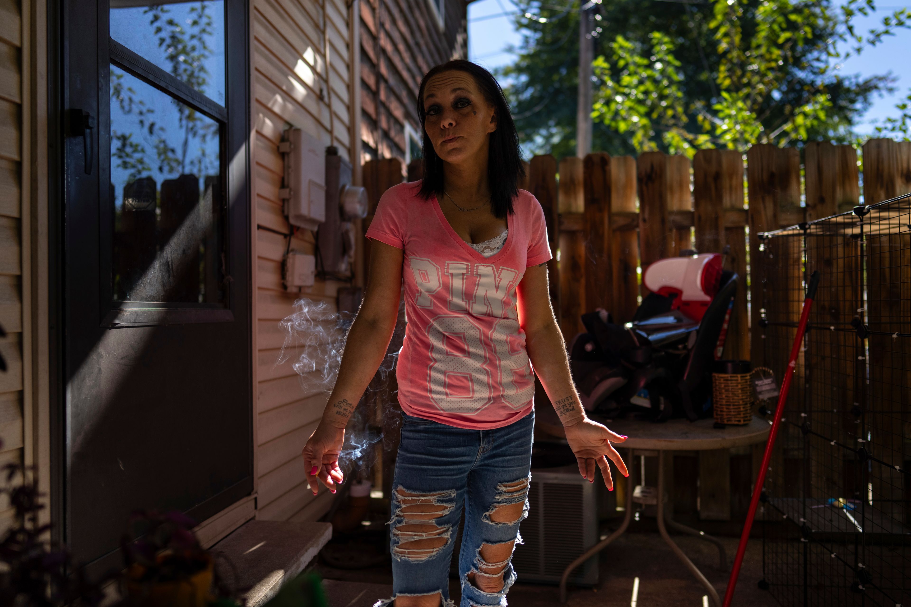 April Youst pauses for a cigarette in her backyard in West Virginia on Wednesday, Oct. 9, 2024. (AP Photo/Carolyn Kaster)