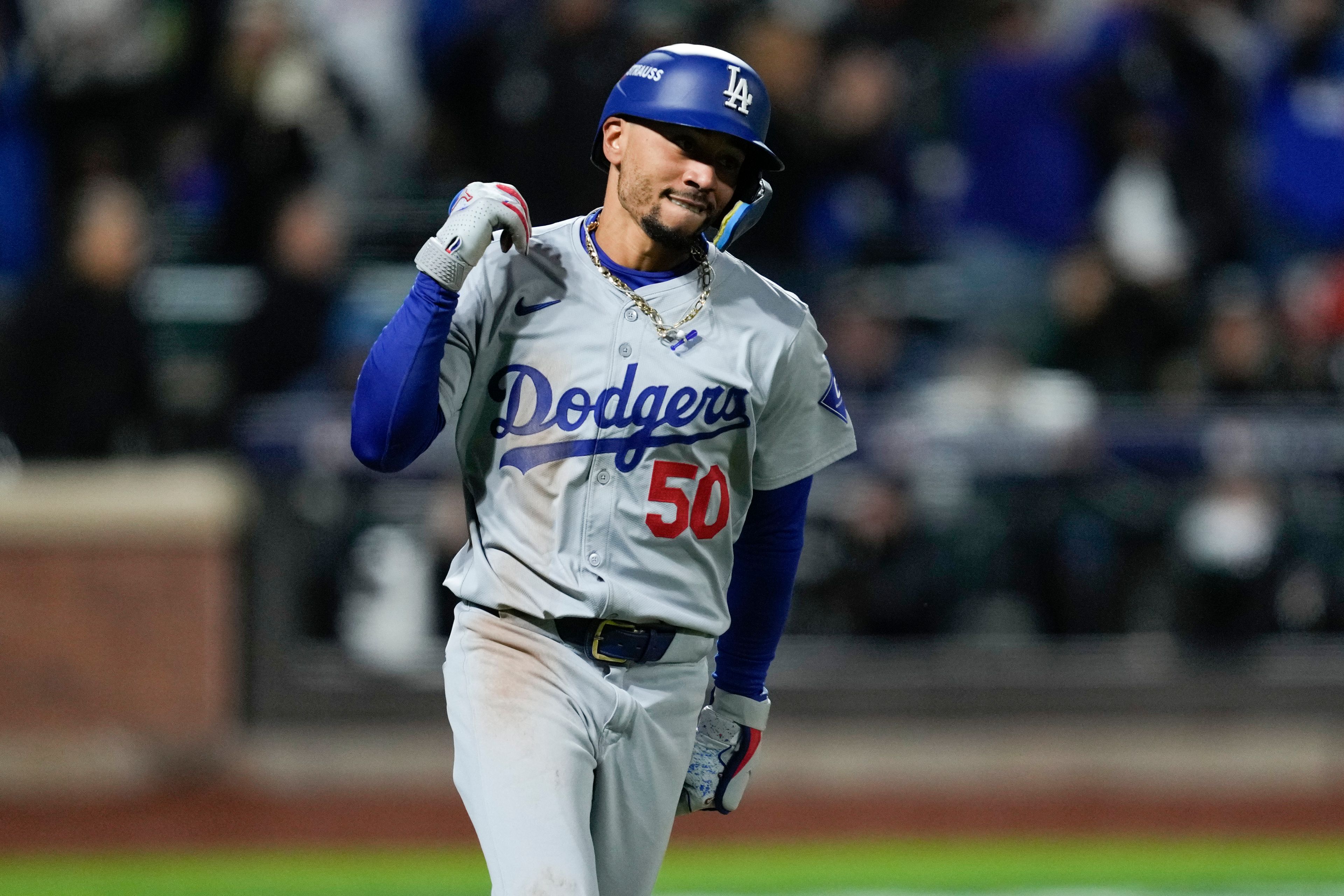 Los Angeles Dodgers' Mookie Betts celebrates after a two-run home run against the New York Mets during the sixth inning in Game 4 of a baseball NL Championship Series, Thursday, Oct. 17, 2024, in New York. (AP Photo/Ashley Landis)