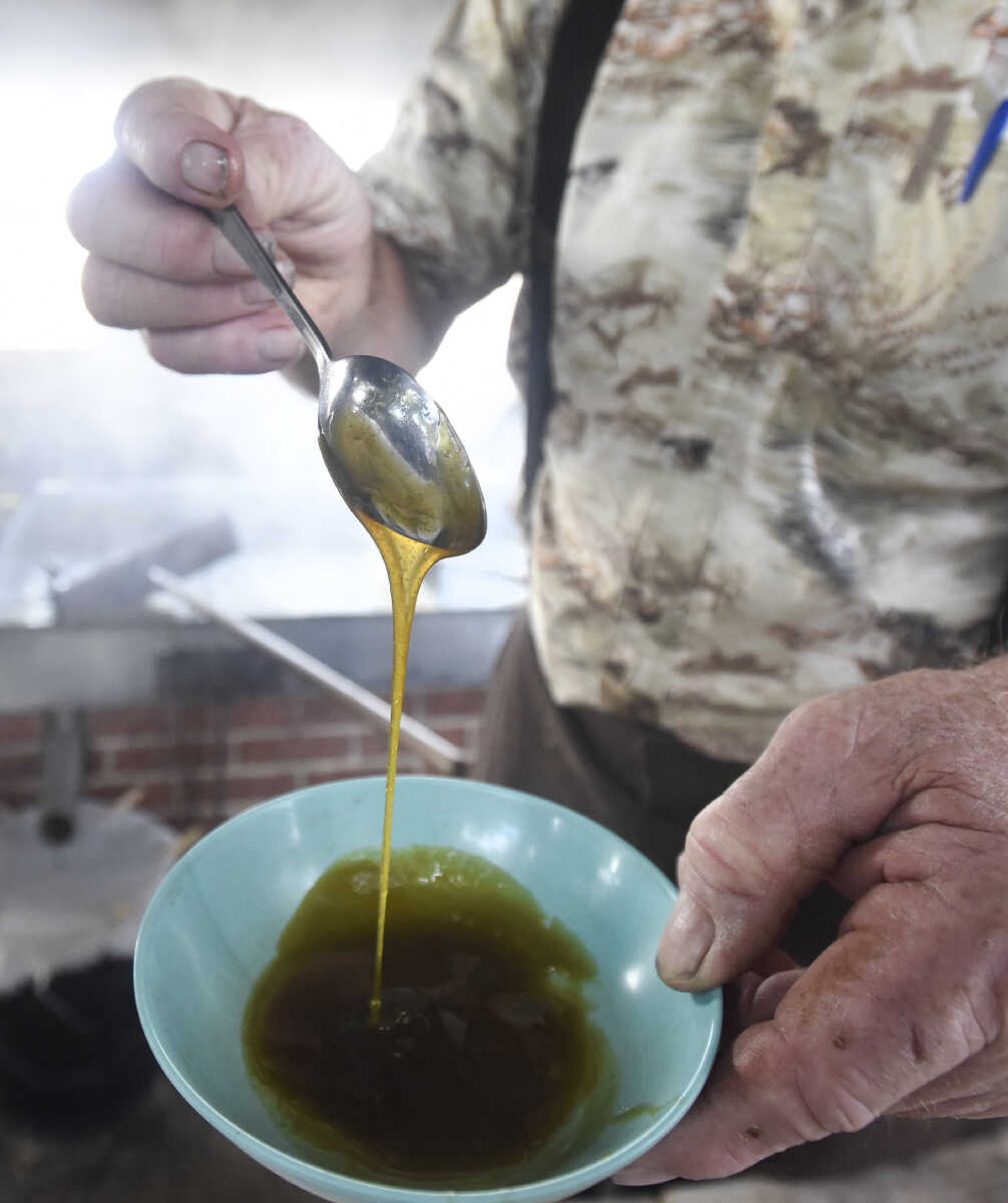 LAURA SIMON ~ lsimon@semissourian.com

Ralph Enderle spoons some fresh sorghum to taste at his New Hamburg, Missouri home on Monday, Oct. 10, 2016.