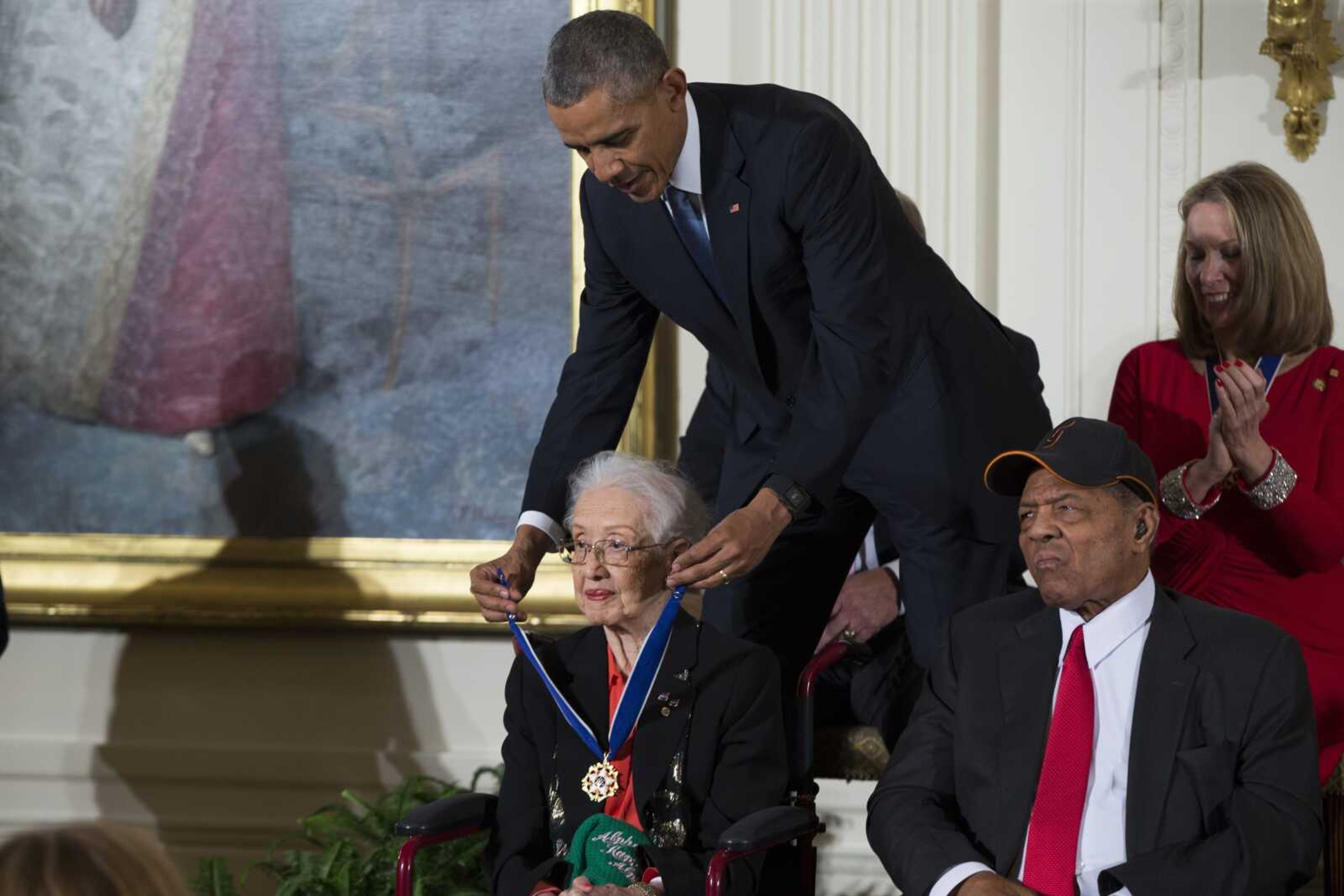 Willie Mays, right, looks on as President Barack Obama presents the Presidential Medal of Freedom to NASA mathematician Katherine Johnson during a Nov. 24, 2015, ceremony in the East Room of the White House in Washington.