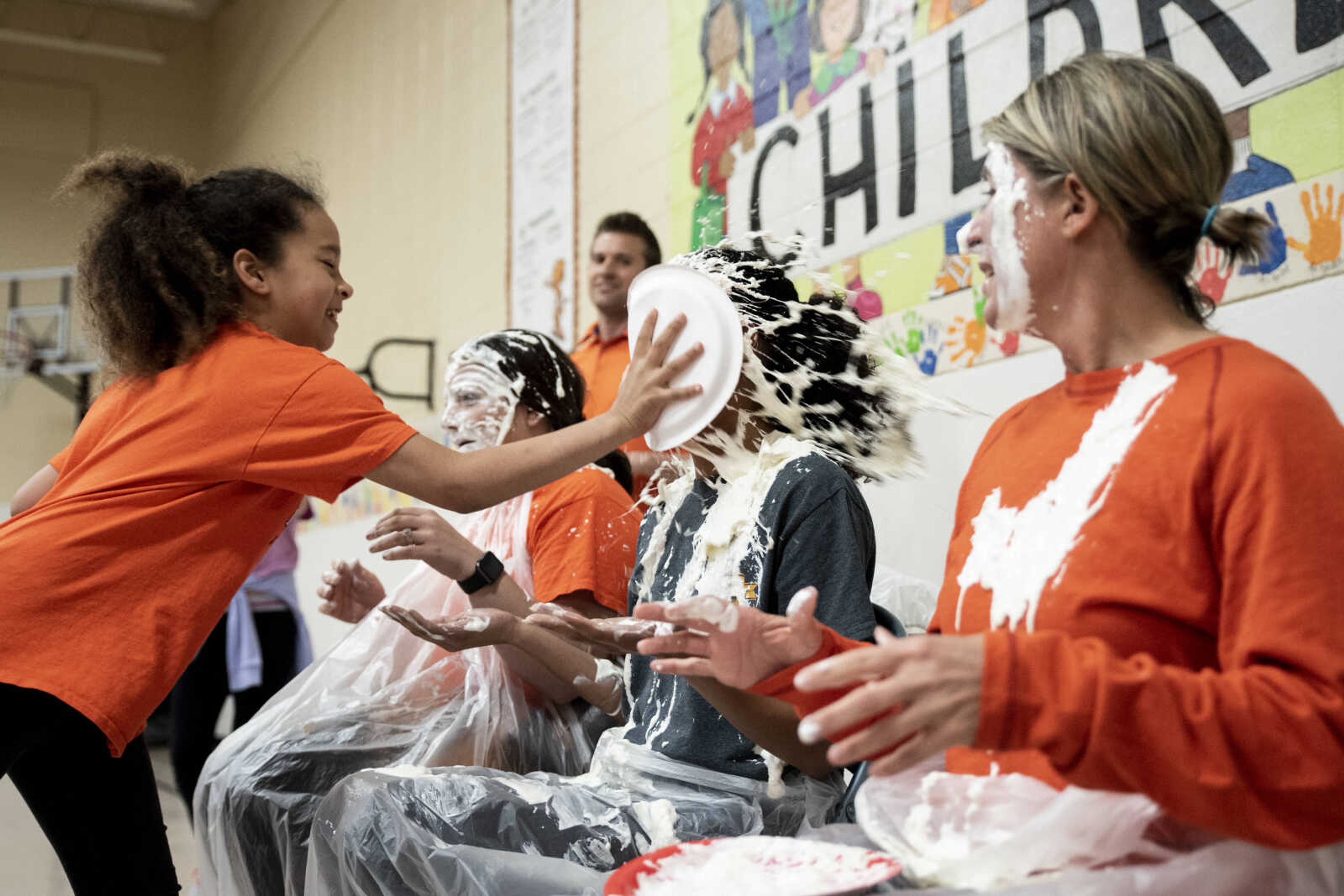 Third grader Jaymaia Ivory pies Charity Owens in the face at Clippard Elementary School Friday, April 5, 2019, in Cape Girardeau. Students earned votes for which teacher(s) would get pied in the face when they brought in donations to raise money for their end-of-the-year play day that is free to students. Through students and other donations, the school raised $550 towards their play day activities.