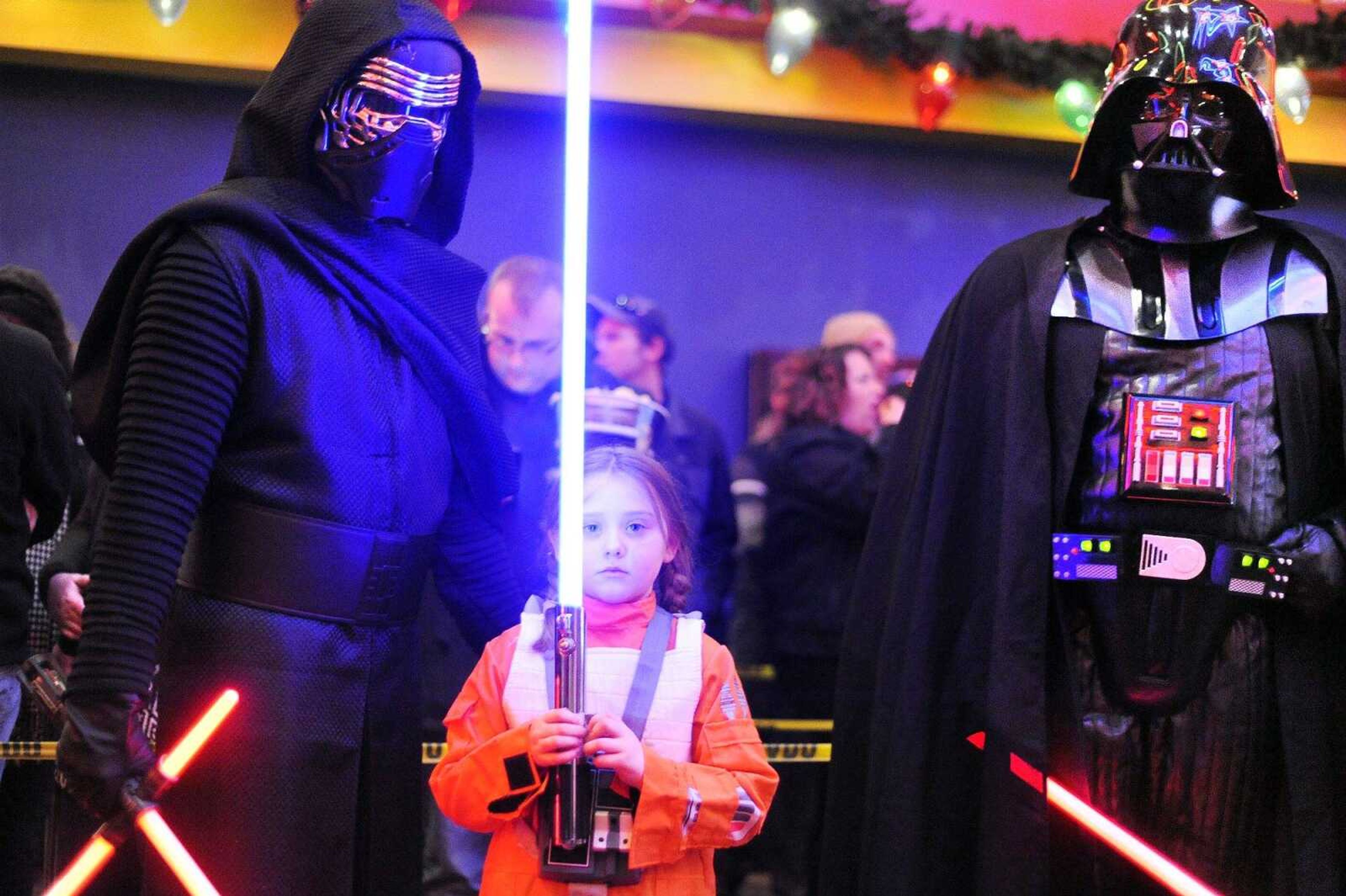 Kylo Ren, left; Alexis Rentfro, center, as a wing pilot; and Darth Vader entertain fans Thursday in the atrium of Cape West 14 Cine before the premier of "Star Wars: The Force Awakens." (Laura Simon)