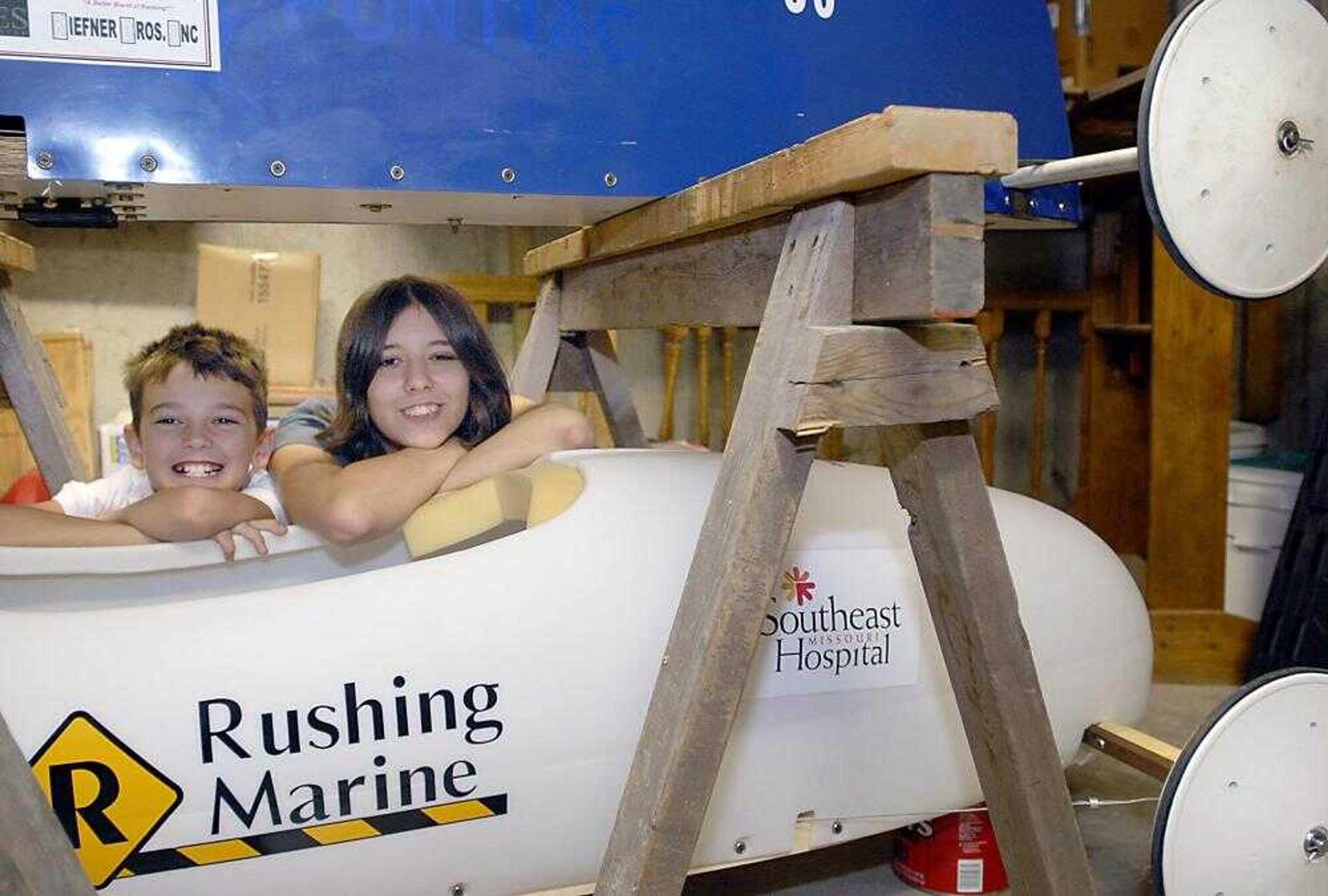 Siblings Jordan and April Little posed Thursday with soap boxes at Rushing Marine in Jackson. The two are competing in the All-American Soap Box Derby in Akron, Ohio. (Kit Doyle)