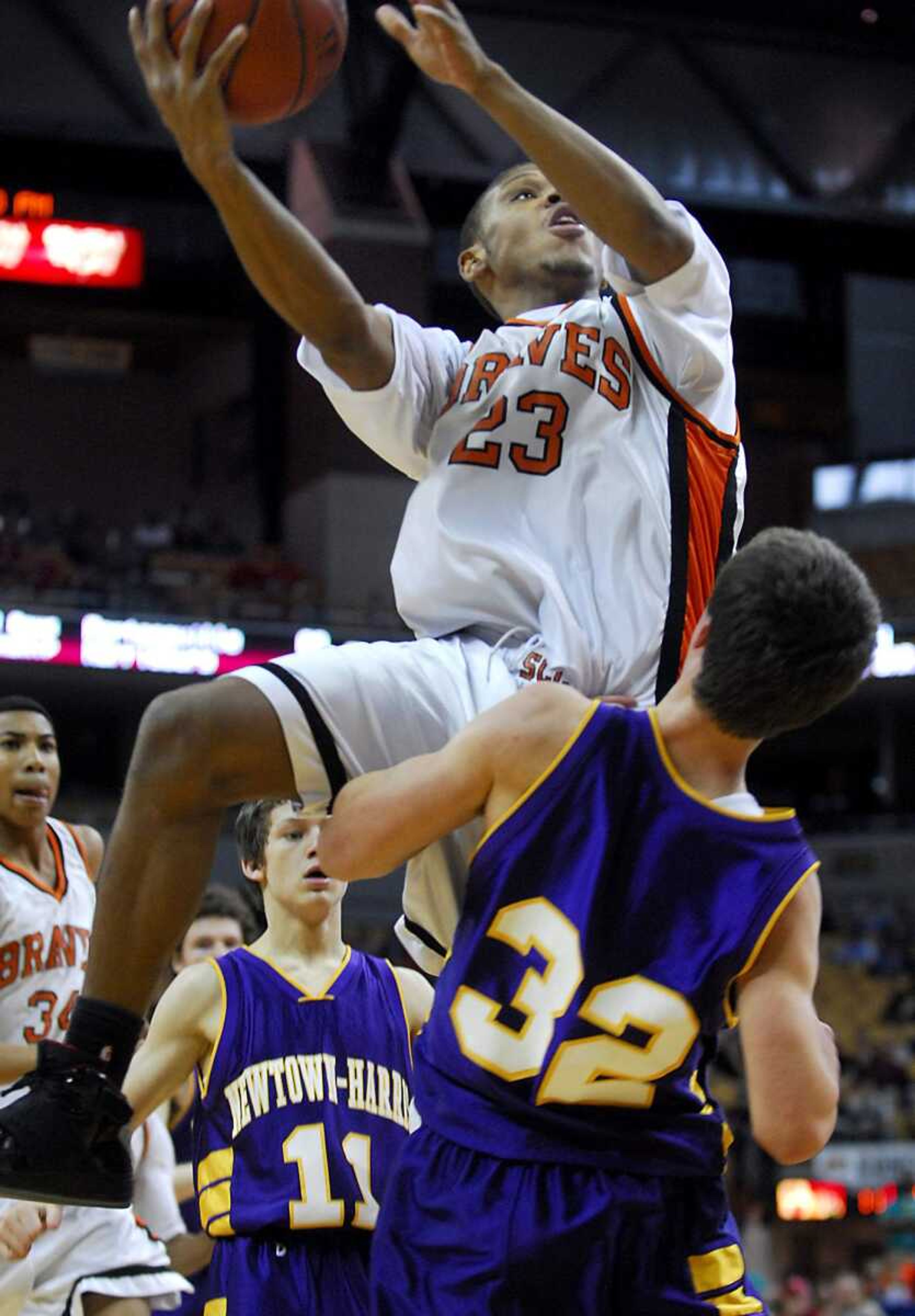 KIT DOYLE ~ kdoyle@semissourian.com
Braves senior Drew Thomas scores over Newtown-Harris defender Japheth Busick Saturday, March 21, 2009, in the Class 1 state championship at Mizzou Arena in Columbia.  Thomas finished with 29 points.