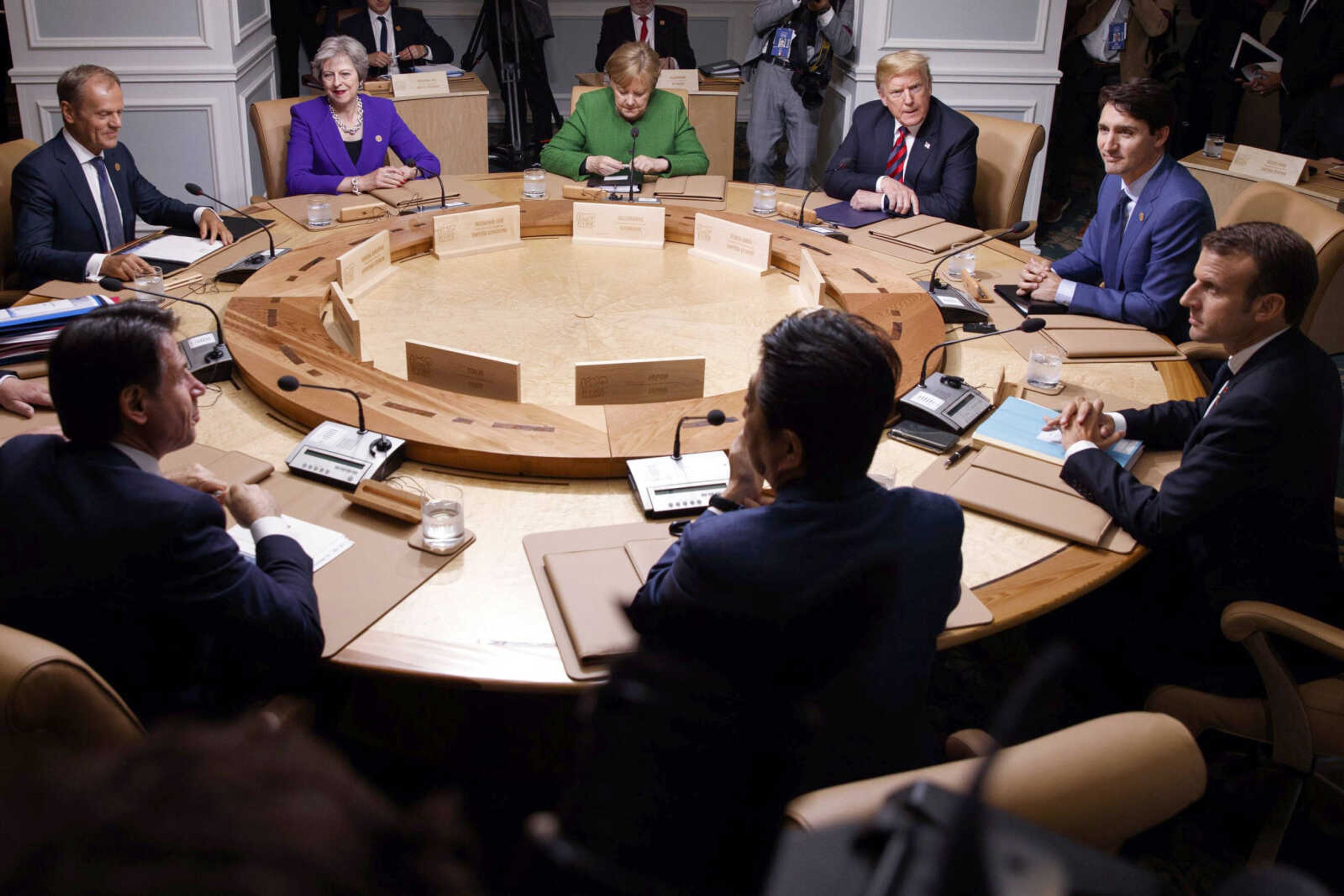 Clockwise from top left, President of the European Council Donald Tusk, British Prime Minister Theresa May, German Chancellor Angela Merkel, U.S. President Donald Trump, Canadian Prime Minister Justin Trudeau, French President Emmanuel Macron, Japanese Prime Minister Shinzo Abe and Italian Prime Minister Giuseppe Conte participate in a working session Friday at the G-7 summit in Charlevoix, Canada.