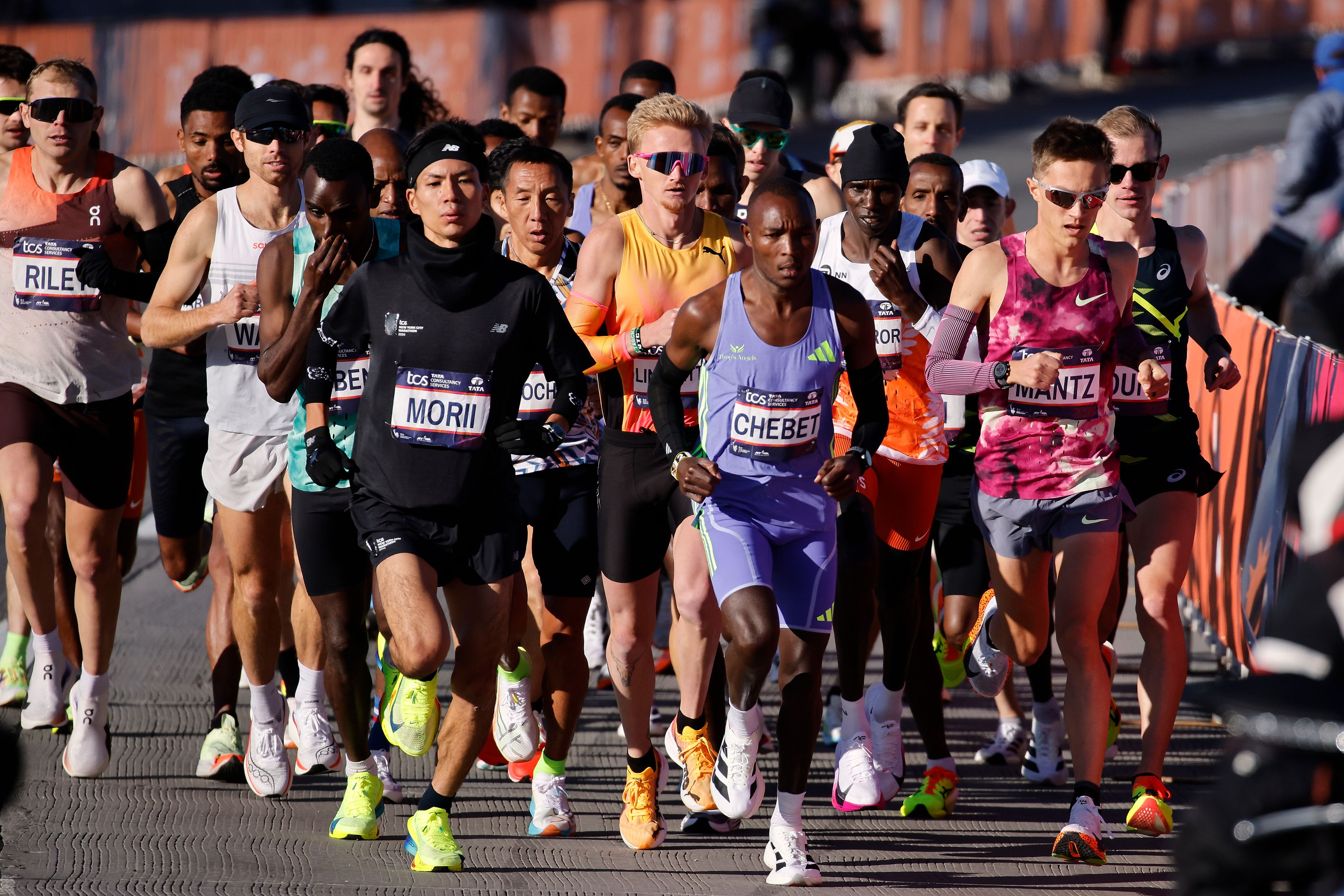 Yuma Morii, left, of Japan, makes his way onto the Verrazzano Narrows bridge with runners in the men's elite division make their way from the start line during the New York City Marathon, Sunday, Nov. 3, 2024, in New York. (AP Photo/Eduardo Munoz Alvarez)