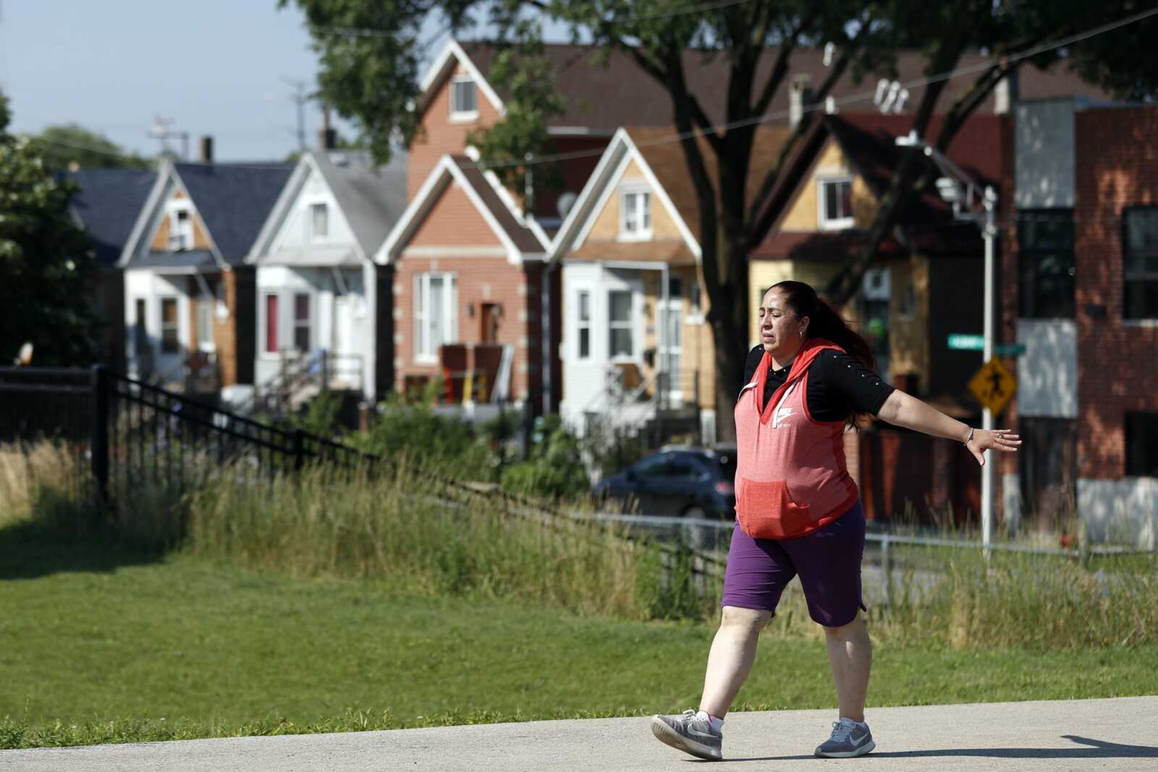 Eugenia Rodriguez walks July 1 in Chicago's La Villita Park. She is required to get out for a walk or a run every morning to keep her varicose veins active and hasn't been eligible for insurance coverage after overstaying a visitor visa from Mexico. Rodriguez used to wake up every two or three hours at night to check on her mother in their Chicago home. Since getting insurance through the Illinois program, her mother has proper medications.