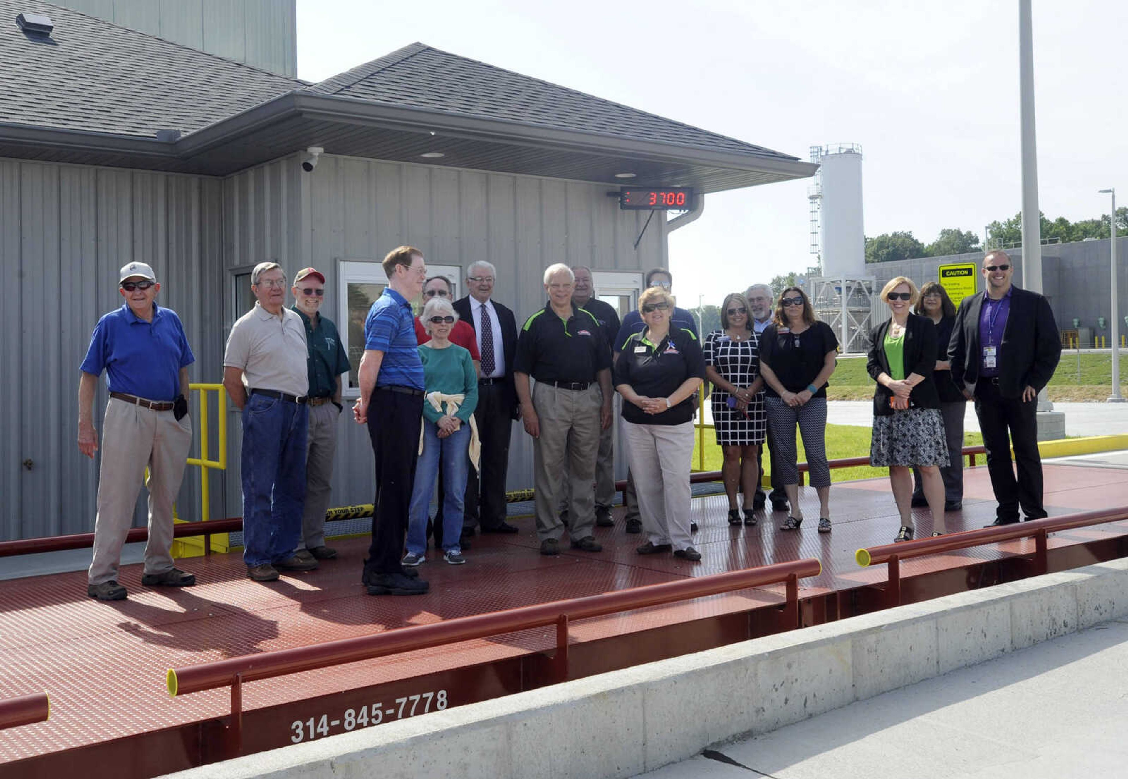 Visitors pose for a photo on the scale at the new solid-waste transfer station Monday, May 23, 2016 in Cape Girardeau.