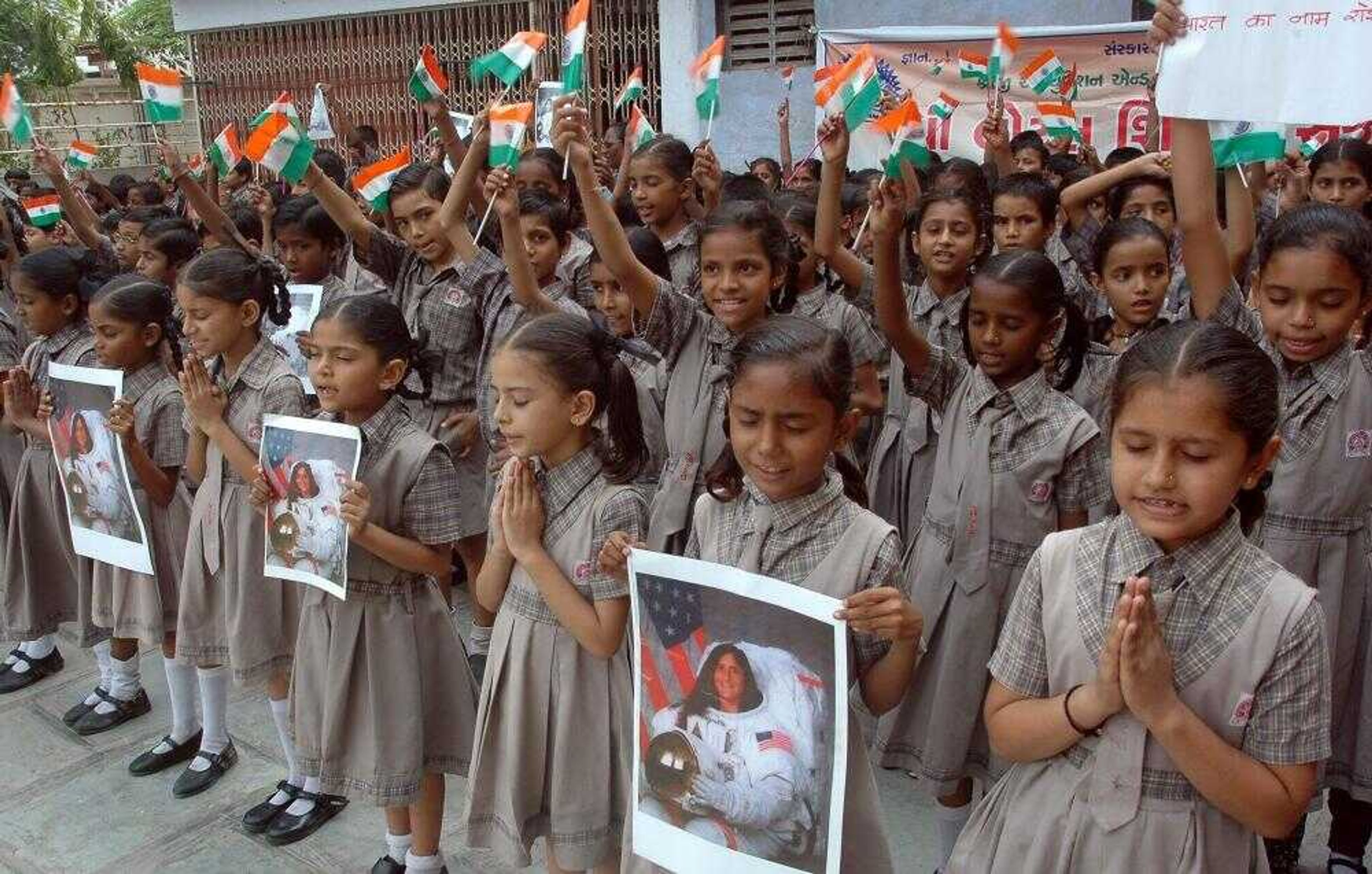 Schoolchildren in Ahmadabad, India, held portraits Tuesday of astronaut Sunita Williams, who is of Indian origin, and prayed for her safe return from space. After a nearly 10-day stay at the international space station that included construction work and a computer meltdown, space shuttle Atlantis was cleared to begin its return trip to Earth. The shuttle is bringing back Williams, a U.S. astronaut and former space station resident whose more than six months in space set a record for the longest single spaceflight by a woman. (Ajit Solanki ~ Associated Press)