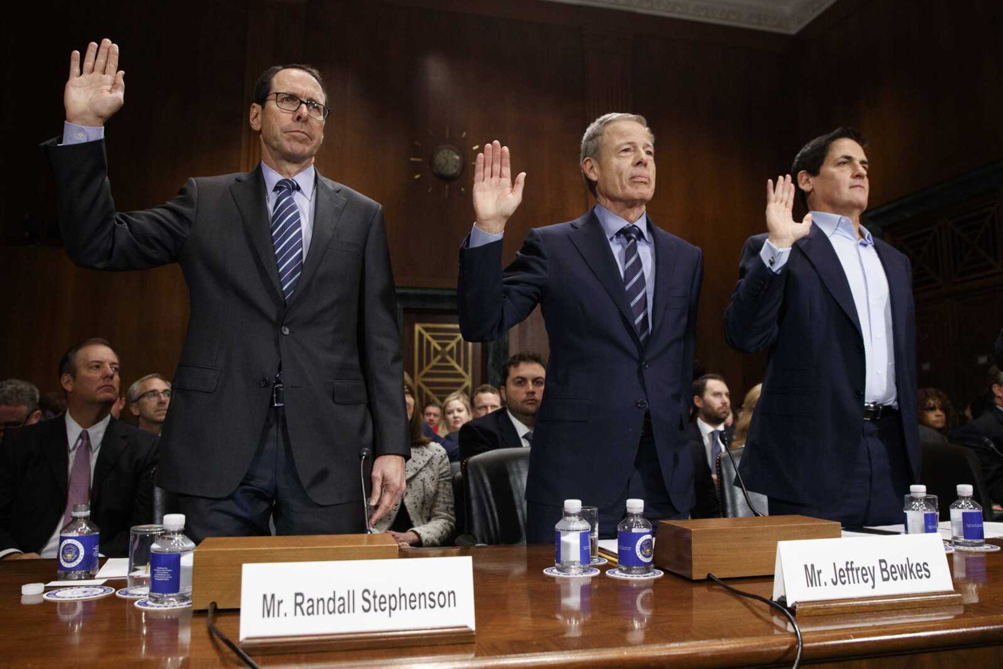 From left, AT&T chairman and CEO Randall Stephenson, Time Warner chairman and CEO Jeffrey Bewkes and AXS TV chairman and Dallas Mavericks owner Mark Cuban are sworn in Wednesday on Capitol Hill in Washington before testifying before a Senate Judiciary subcommittee hearing on the proposed merger between AT&T and Time Warner.