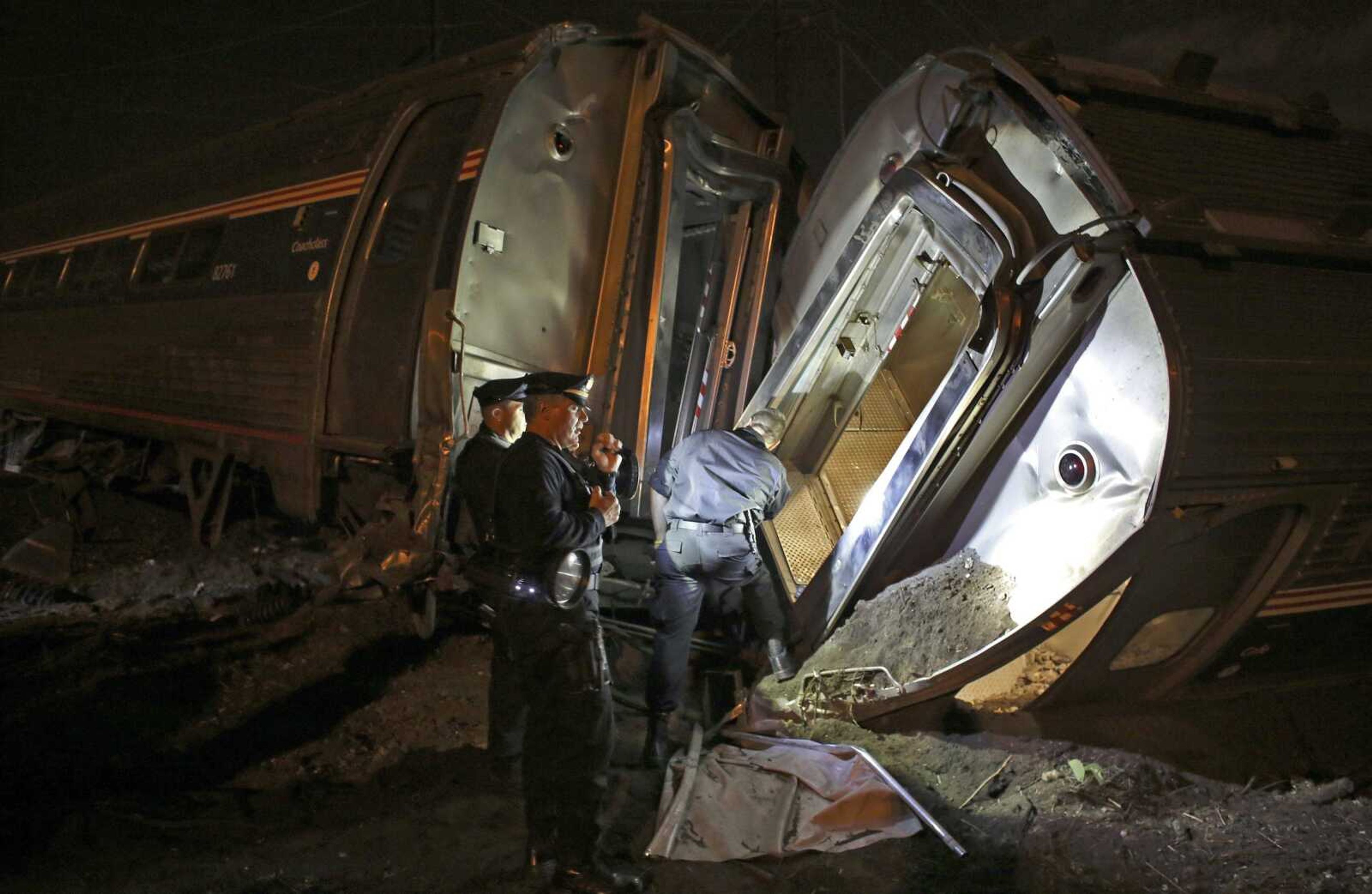 Emergency personnel work the scene of a train wreck of an Amtrak train that derailed and crashed May 15 in Philadelphia. (Joseph Kaczmarek ~ Associated Press)