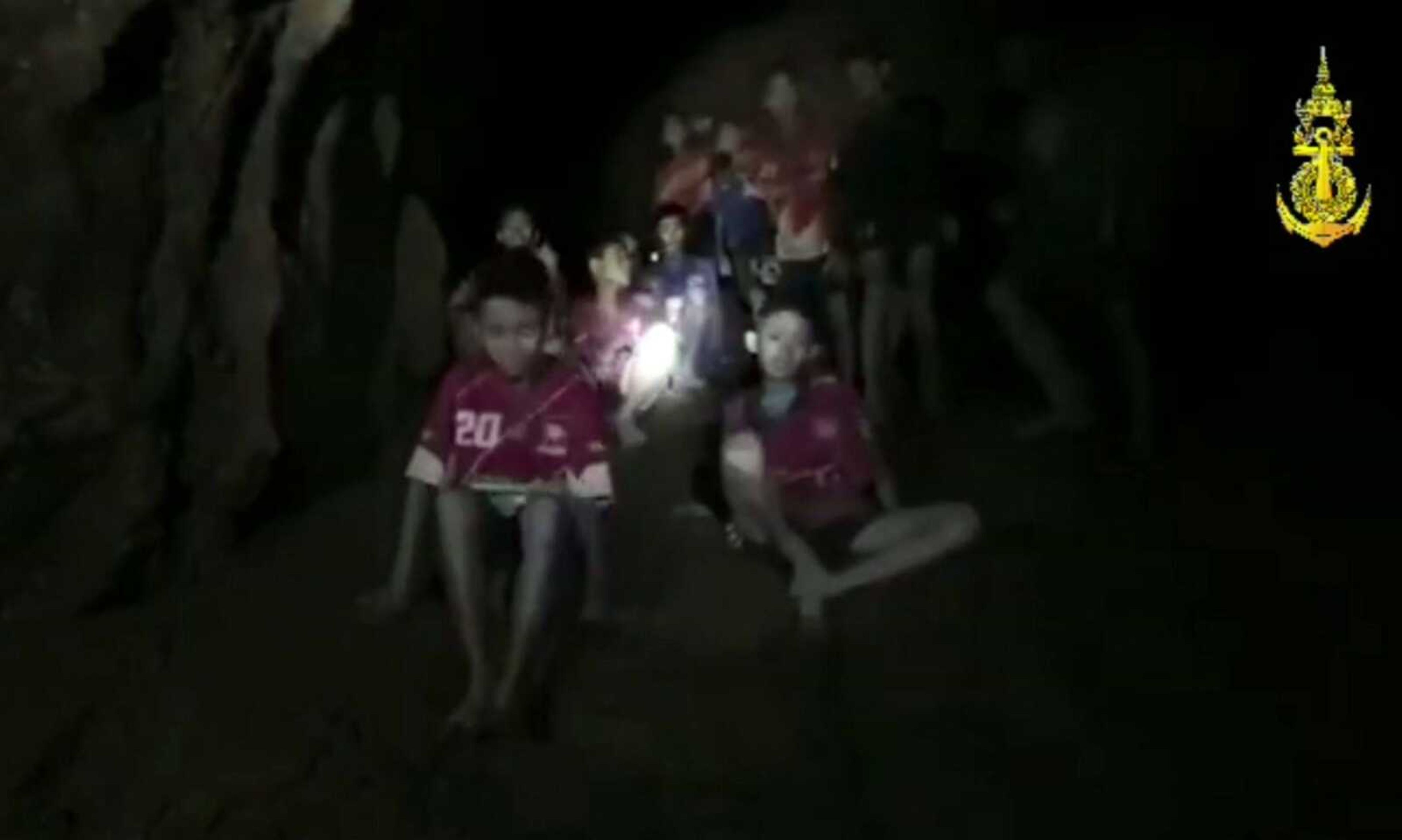 In this grab taken from video provided by the Thai Navy, a view of the boys and their soccer coach as they are found Monday in a cave in Chiang Rai in Thailand. Rescuers found all 12 boys and their soccer coach alive deep inside a partially flooded cave in northern Thailand, more than a week after they disappeared and touched off a desperate search.