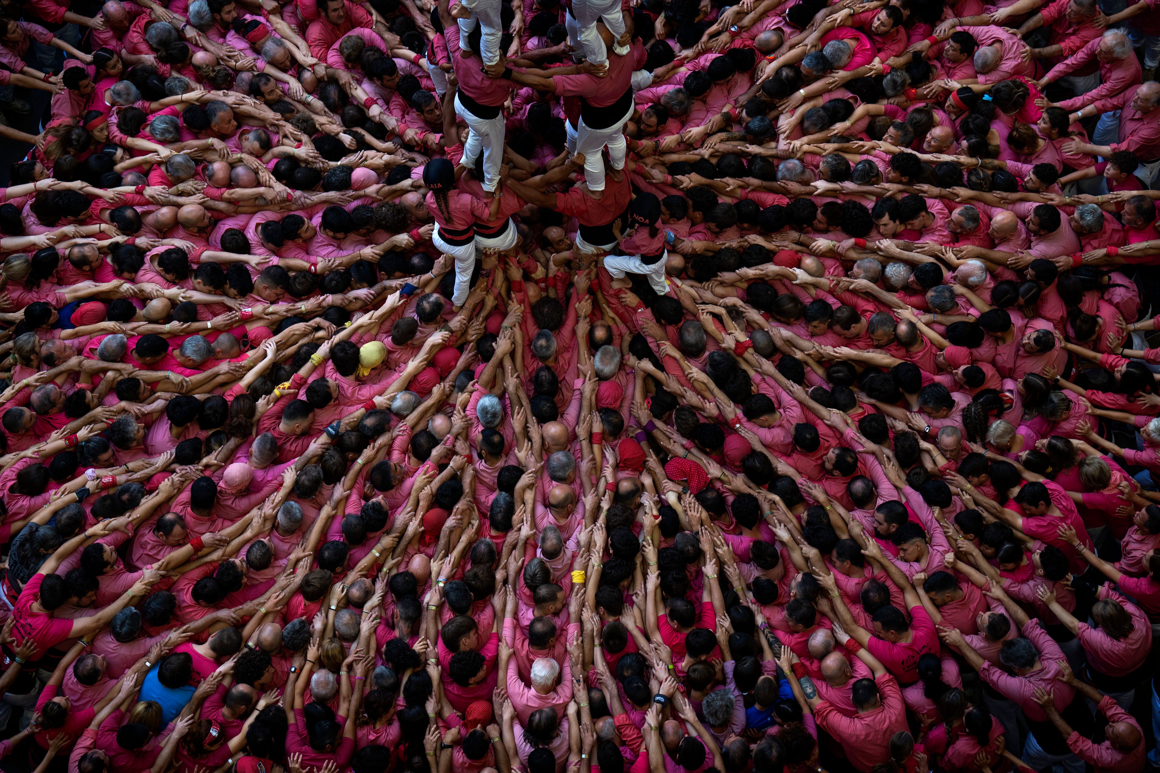 Members of "Moixiganguers d'Igualada" form a "Castell" or human tower, during the 29th Human Tower Competition in Tarragona, Spain, Sunday, Oct. 6, 2024. (AP Photo/Emilio Morenatti)