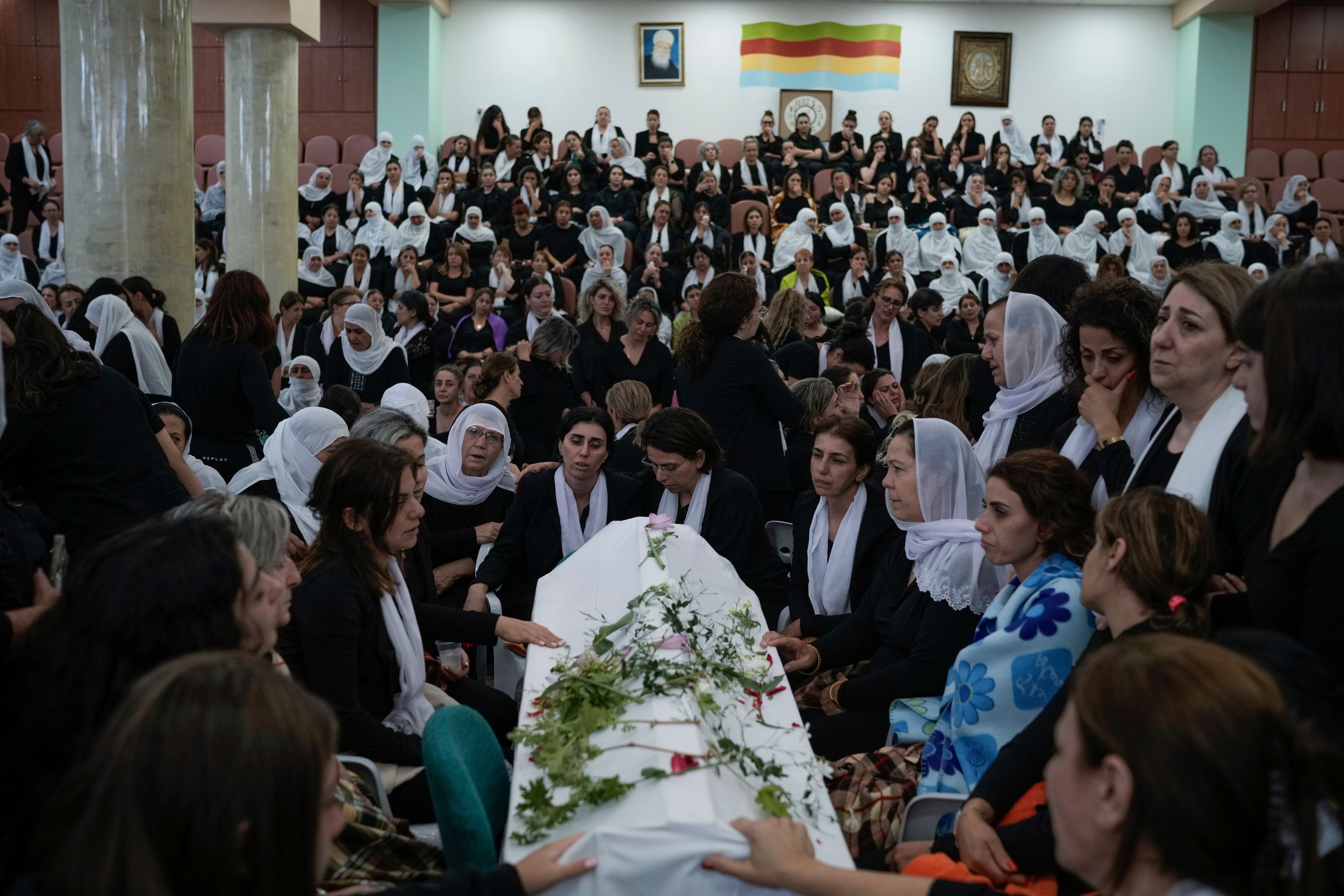 Members of the Druze minority mourn during the funeral of their relatives at the village of Majdal Shams in the Israeli-controlled Golan Heights, Sunday, July 28, 2024. A rocket strike at a soccer field in the village has killed at least 11 children and teens. It's the deadliest strike on an Israeli target along the country's northern border since the fighting between Israel and the Lebanese militant group Hezbollah began. (AP Photo/Leo Correa)