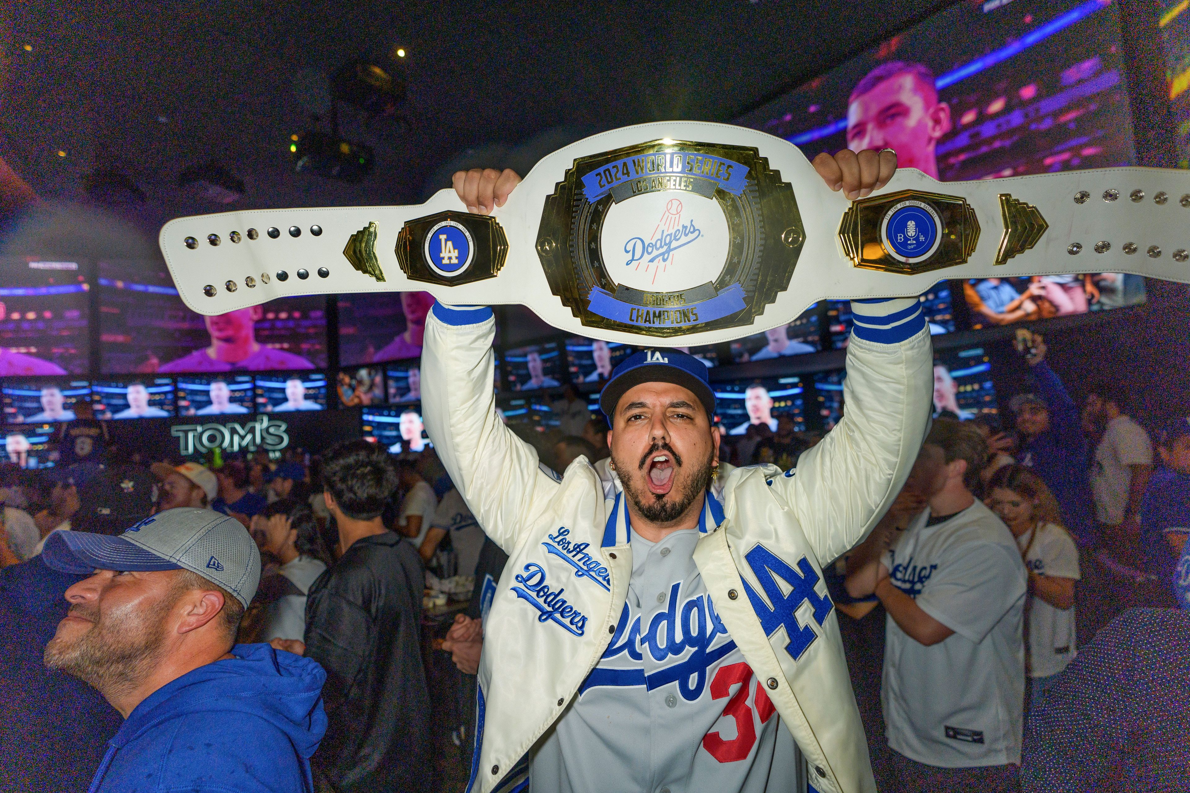 Fans celebrate after the Los Angeles Dodgers defeated the New York Yankees to win the baseball World Series Wednesday, Oct. 30, 2024, in Los Angeles. (AP Photo/Damian Dovarganes)