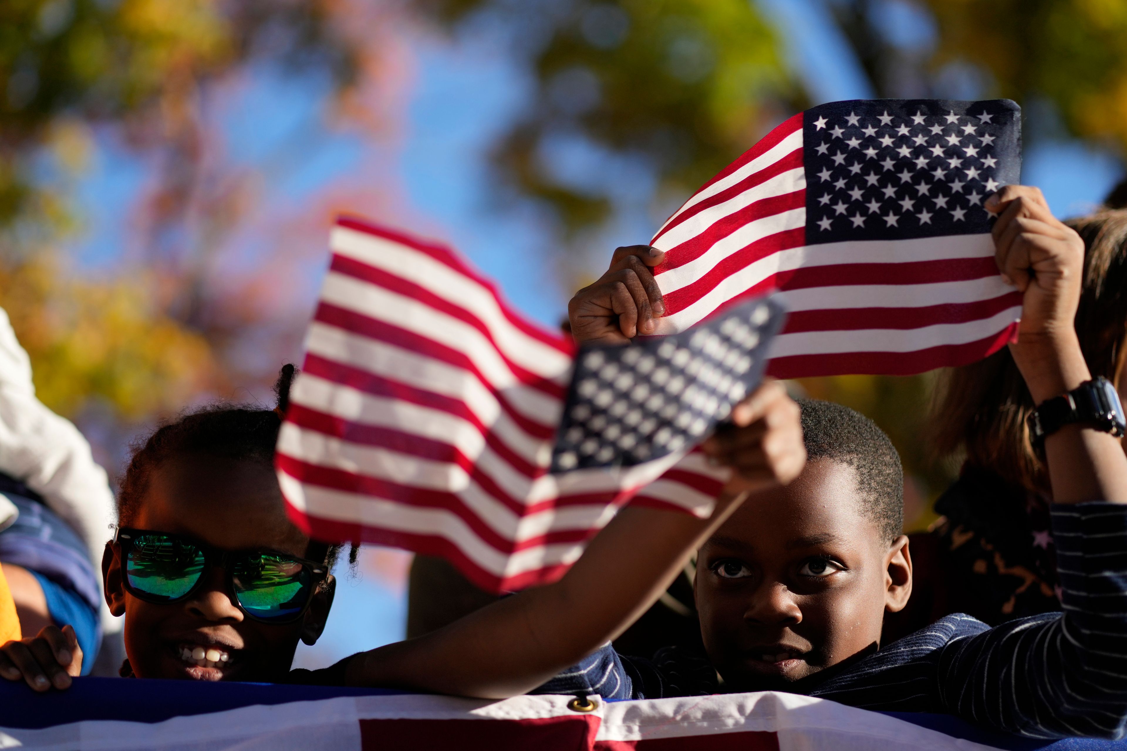 Children listen as Democratic presidential nominee Vice President Kamala Harris speaks during a campaign event at Washington Crossing Historic Park, Wednesday, Oct. 16, 2024, in Washington Crossing, Pa. (AP Photo/Jacquelyn Martin)