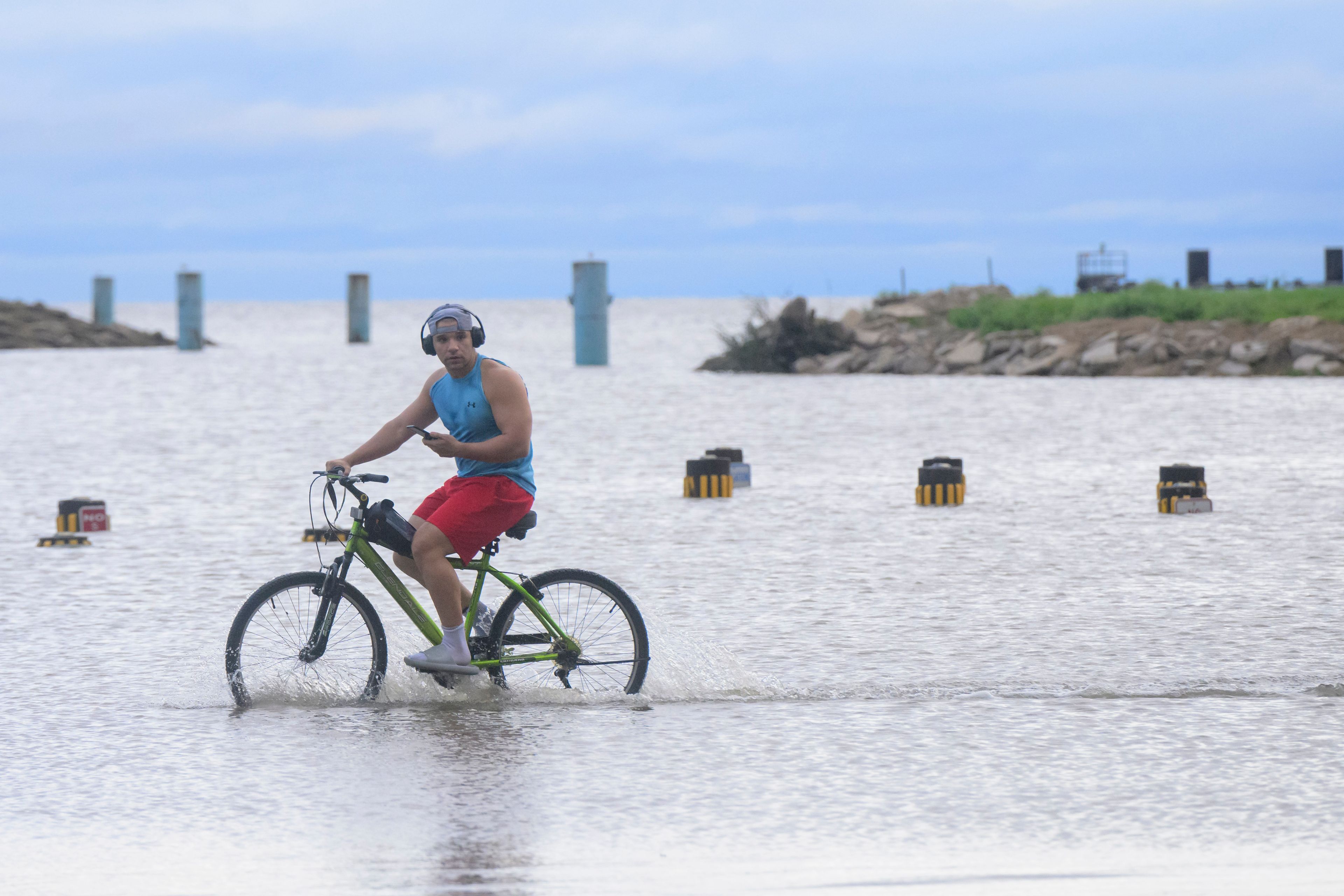 Geral (cq) Hammond pedals through flood water from Hurricane Francine near the entrance to the Treasure Chest Casino in Kenner, La., in Jefferson Parish, Thursday, Sept. 12, 2024. (AP Photo/Matthew Hinton)