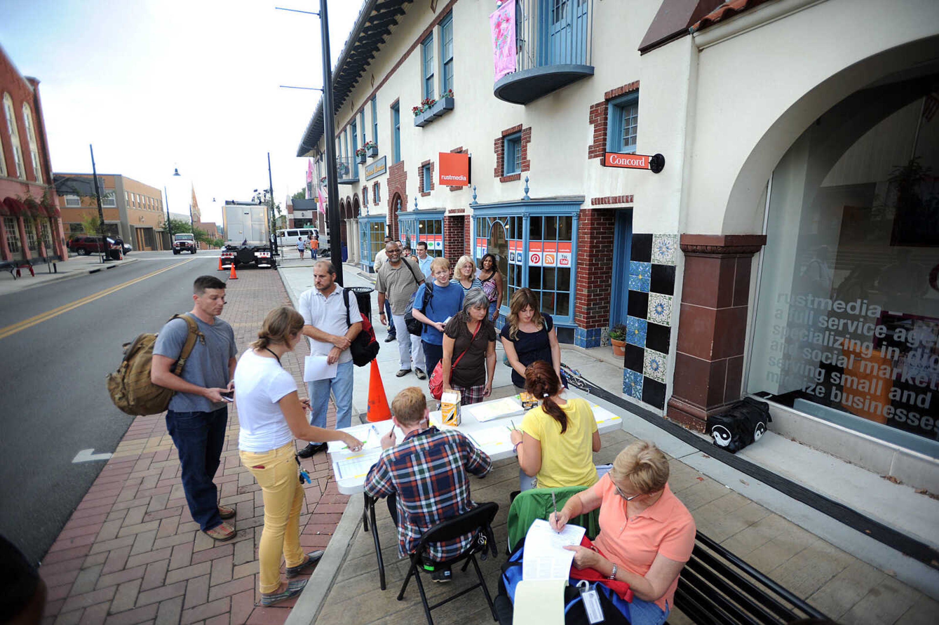 LAURA SIMON ~ lsimon@semissourian.com

Extras for 20th Century Fox's feature film "Gone Girl" line the sidewalk in front of the Southeast Missourian, Thursday, Oct. 3, 2013, in Cape Girardeau.