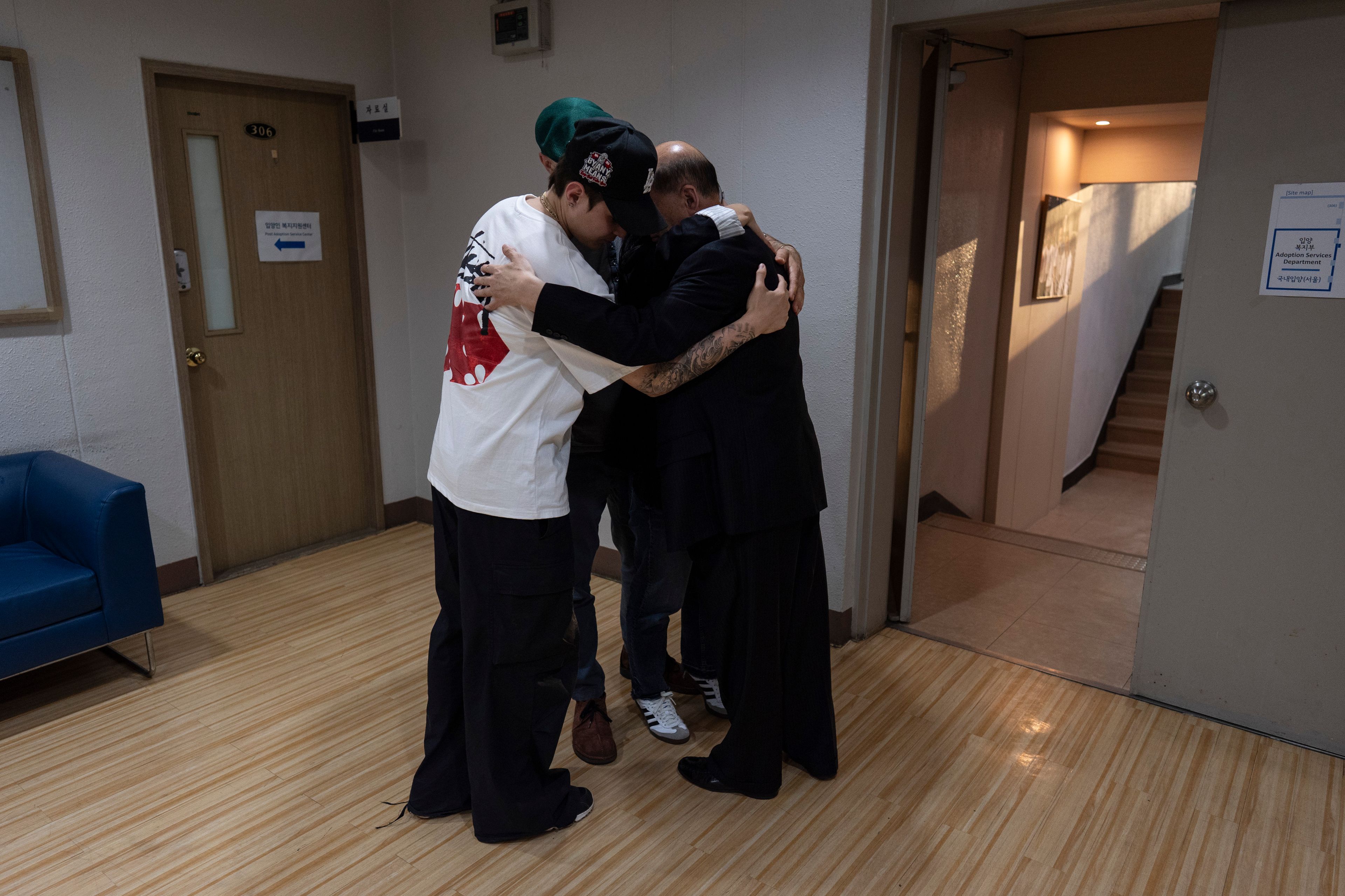 Jang Dae-chang hugs his daughter, Nicole Motta, and her family at the Eastern Social Welfare Society in Seoul on Friday, May 31, 2024, following their emotional first meeting. Motta, whose Korean name is Jang Hyeon-jung, was adopted by a family in Alabama, United States, in 1985. (AP Photo/Jae C. Hong)