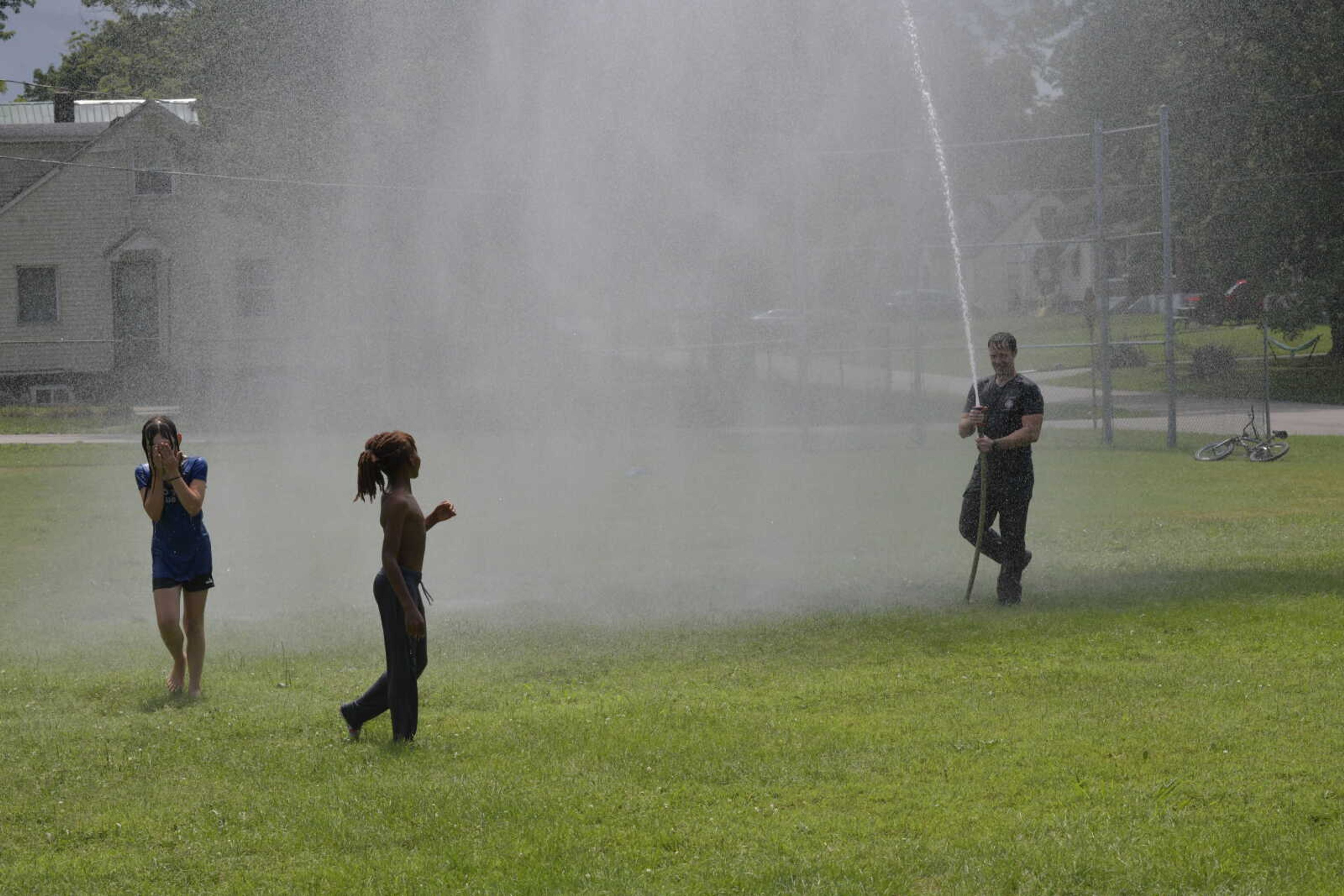 Driver and Operator at the Cape Girardeau Fire Department Zach Brooks keeps the kids cool using one of the water systems used by the department at the first Fireman Friday's held by the department.