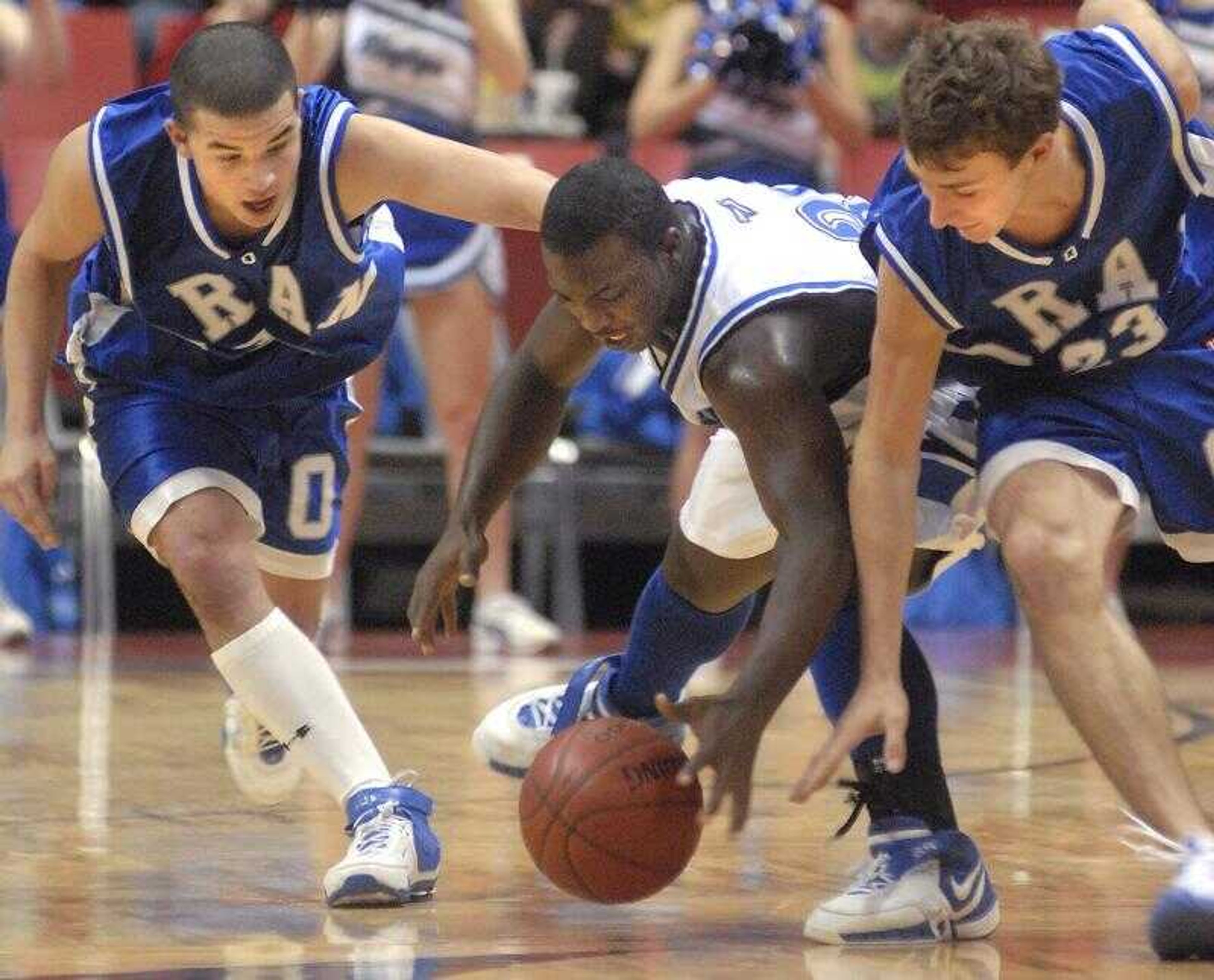 Charleston's Jerquawn Sherrell, center, went after a loose ball with Oran's Cody Romas, left, and Hunter Glastetter in the fourth quarter Wednesday at the Southeast Missourian Christmas Tournament. (Aaron Eisenhauer)