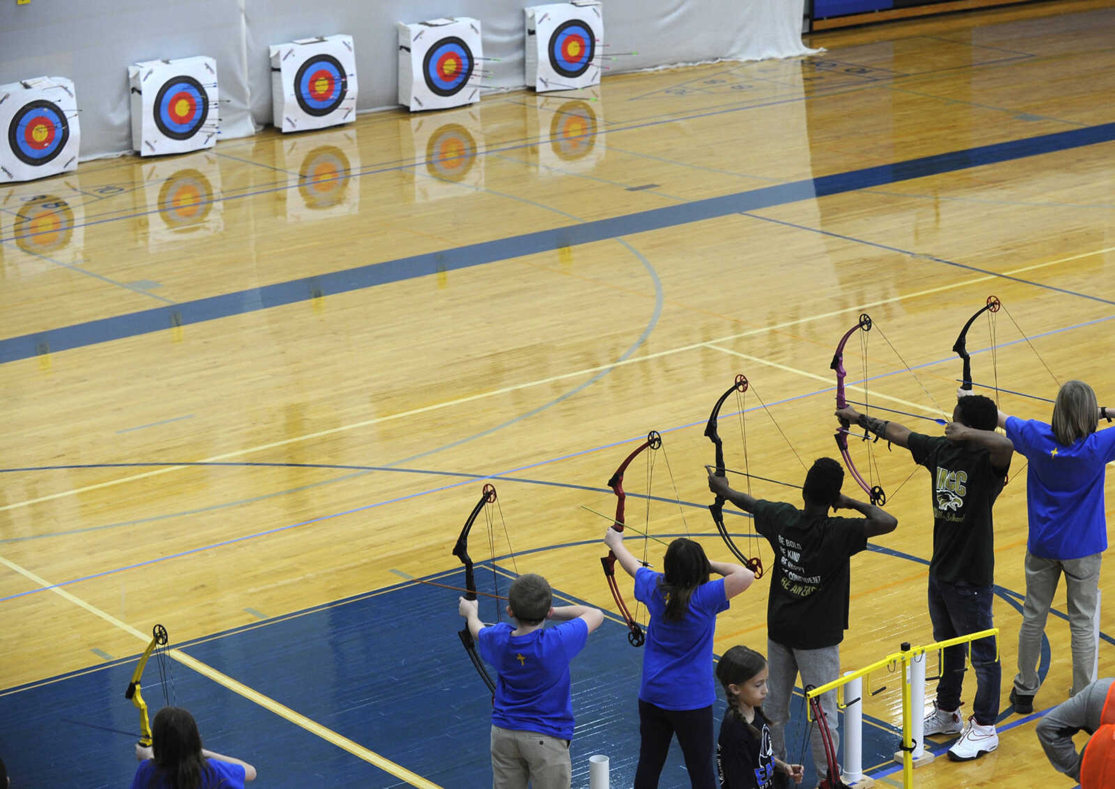 Archers shoot at the targets Saturday, Feb. 3, 2018 during a National Archery in the Schools Program tournament at Immaculate Conception Catholic School in Jackson.