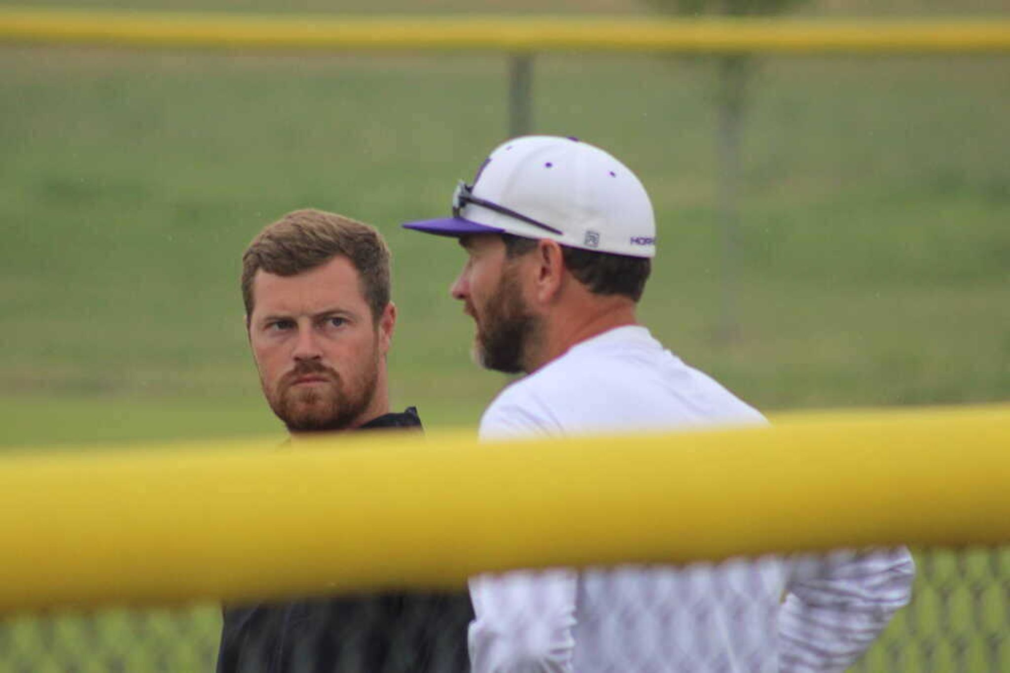 Kennett Lady Indians softball head coach Logan Dollins, left, and Holcomb Lady Hornets softball head coach Matt Casper chat at a regular season matchup at Holcomb.