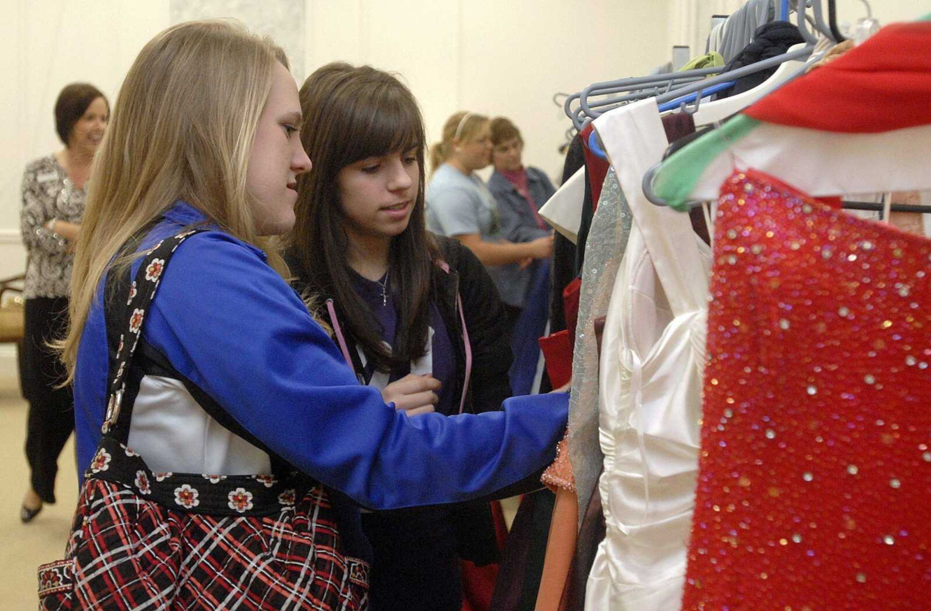 Genny Bradshaw, left, and her friend Courtney Reinagel look through a selection of over 100 dresses Sunday, March 7, 2010 during the March of Dimes fundraiser "Ballgowns for Babies" at The Venue in Cape Girardeau. The fundraiser features used and donated gowns for under $100. The March of Dimes works to improve the health of babies by preventing birth defects, premature birth, and infant mortality. (LAURA SIMON)