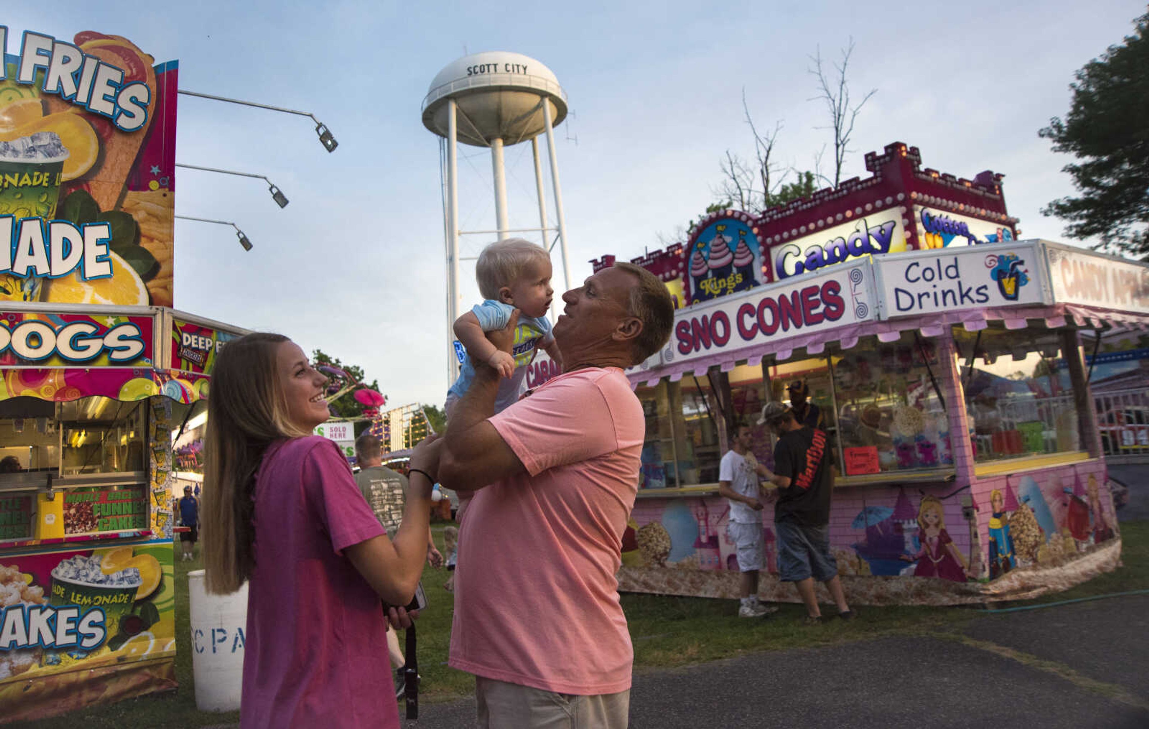 Scott City Mayor Ron Cummins lifts up his grandson Oliver during the 41st annual Mid-Summer Festival Friday, June 16, 2017 at Scott City Park.