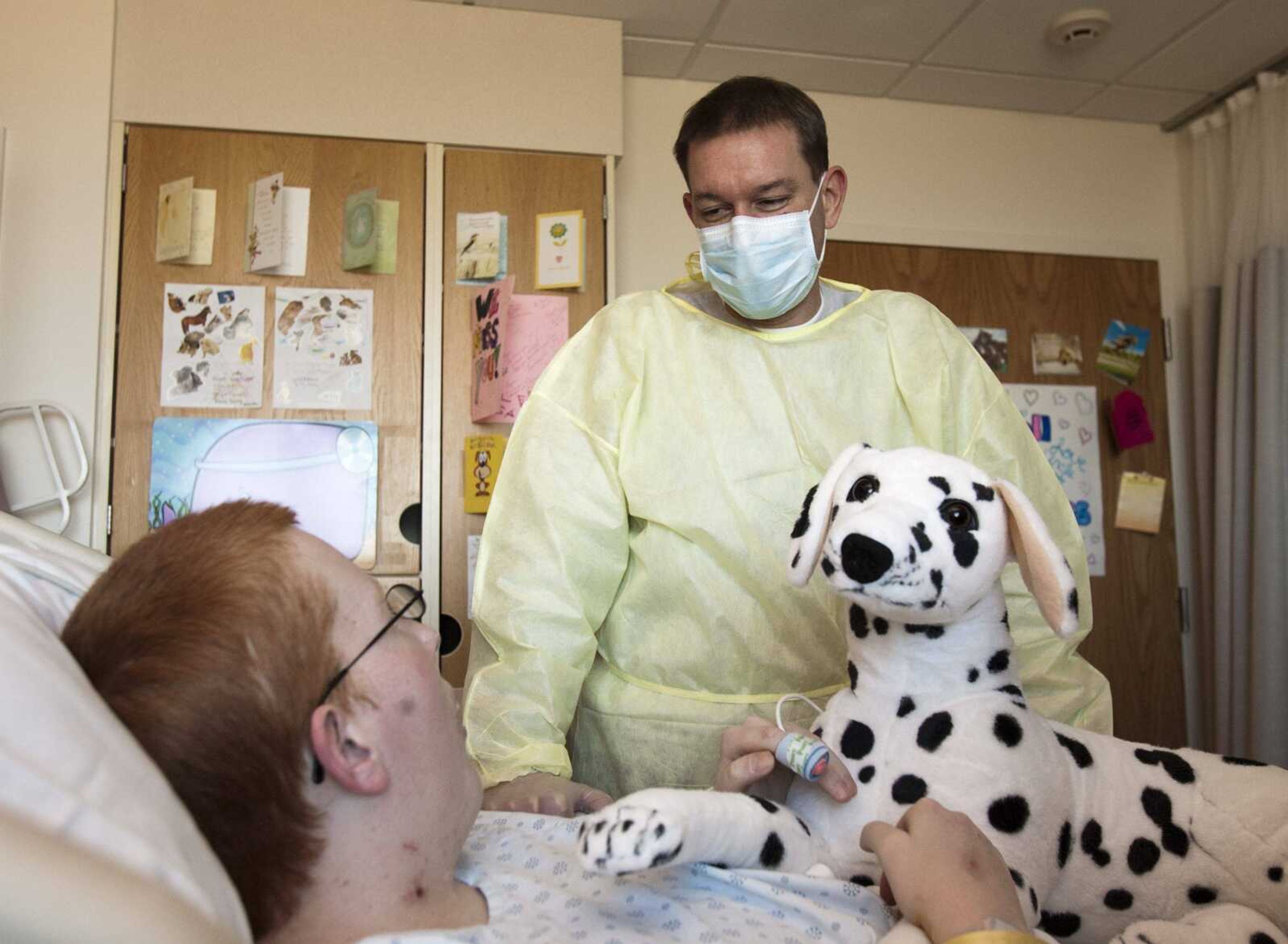 Ryan Damm, 19, a swine flu patient whose life was saved by using a lung-bypass technology called ECMO, sees his physician, Dr. Jeff DeMare, at Children's Hospital of Omaha in Omaha, Neb., on Nov. 20. (NATI HARNIK ~ Associated Press)