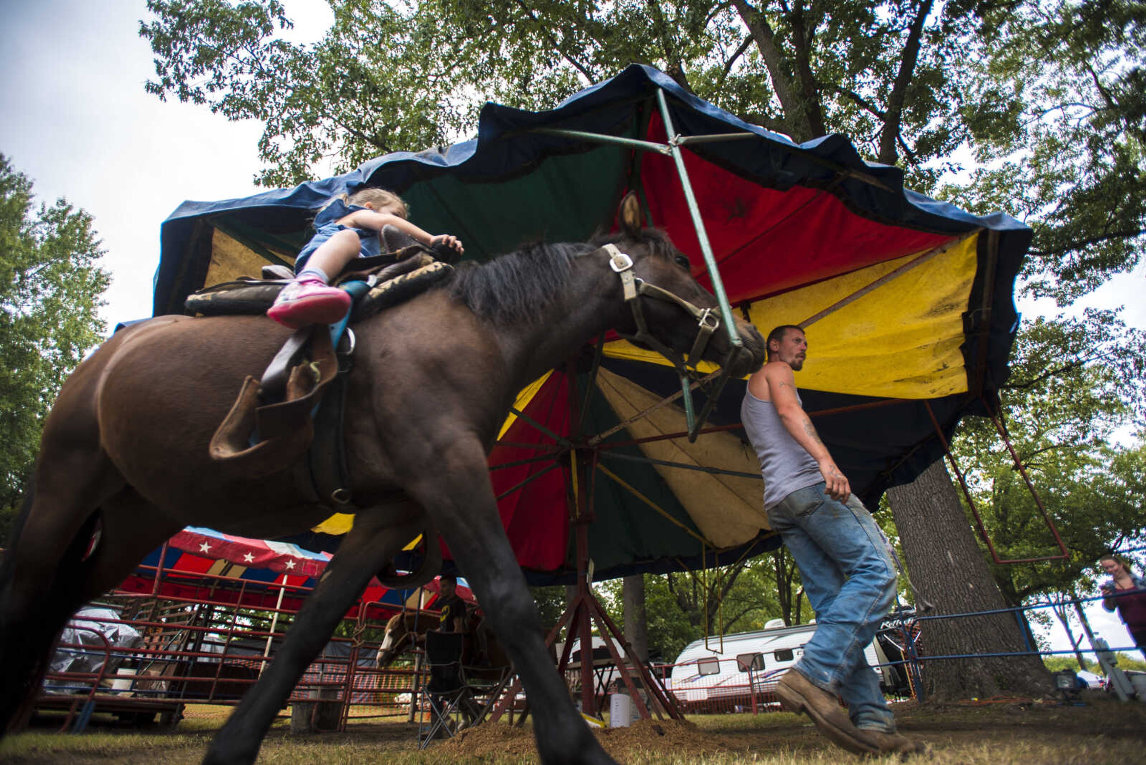 Mary Clare Kohlfeld rides a pony led by Mike Seaton during the SEMO District Fair Wednesday, Sept. 13, 2017 at Arena Park in Cape Girardeau.