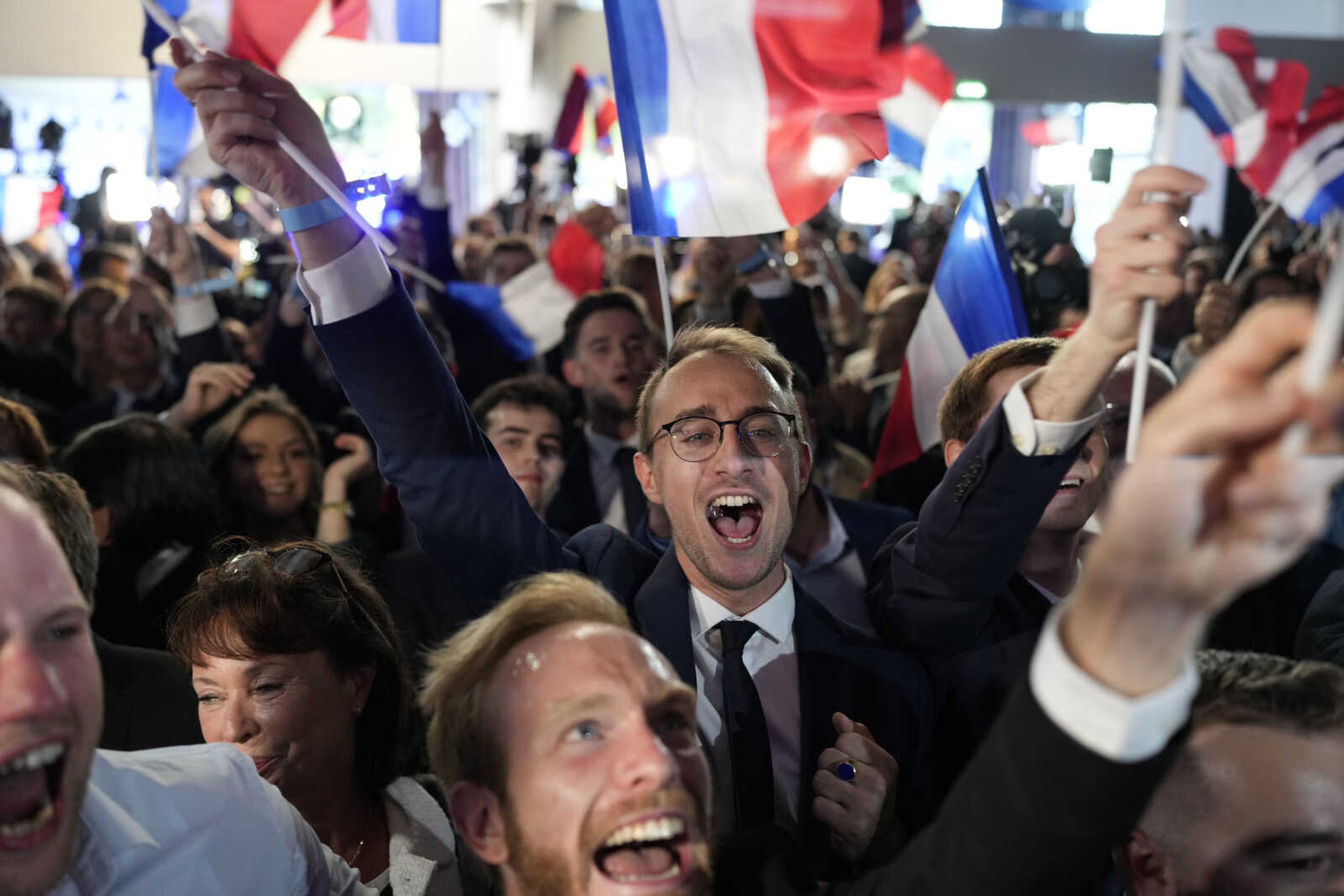 Supporters of French far-right National Rally react at the party election night headquarters Sunday in Paris. First projected results from France put far-right National Rally party well ahead in EU elections, according to French opinion poll institutes.