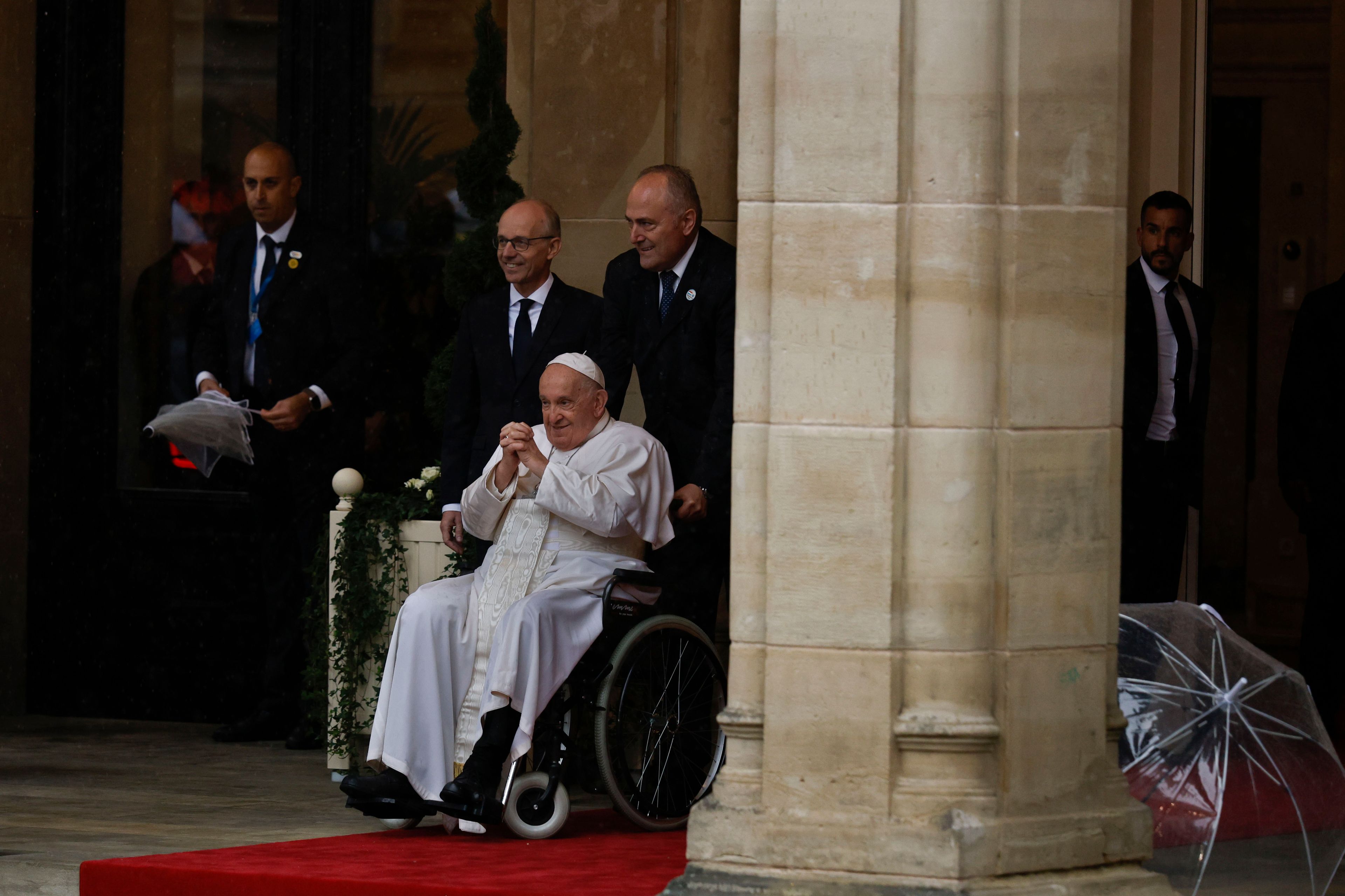 Pope Francis is received by Luxembourg's Prime Minister Luc Frieden, left, as he arrives at the Cercle-Cite convention center in Luxembourg for a meeting with the national authorities and the civil society on the first day of his four-day visit to Luxembourg and Belgium, Thursday, Sept. 26, 2024. (AP Photo/Omar Havana)