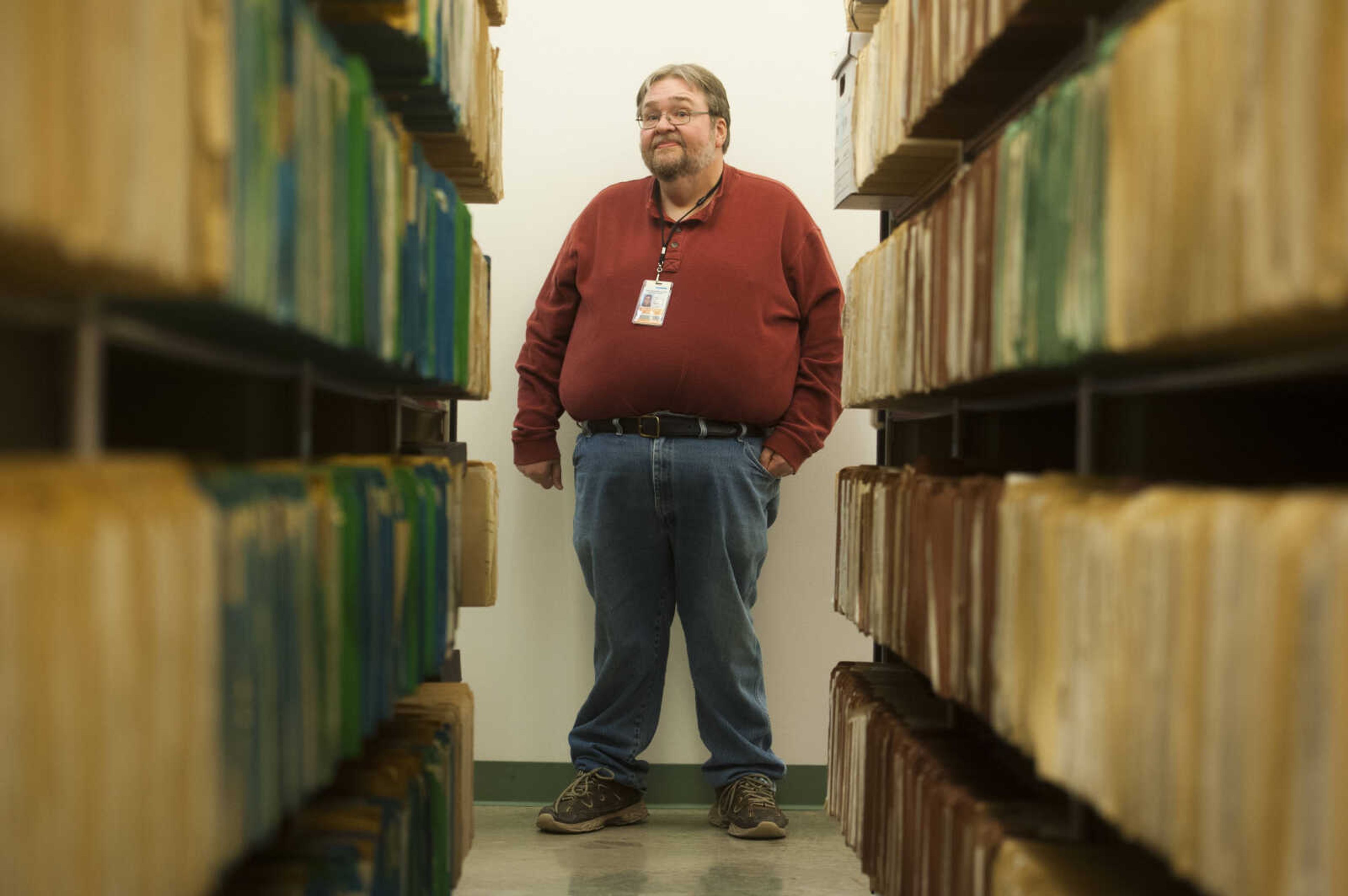 Archive director Steve Pledger looks down a row of archived court documents Thursday, March 8, 2018, at the Cape Girardeau County Archive Center in Jackson.