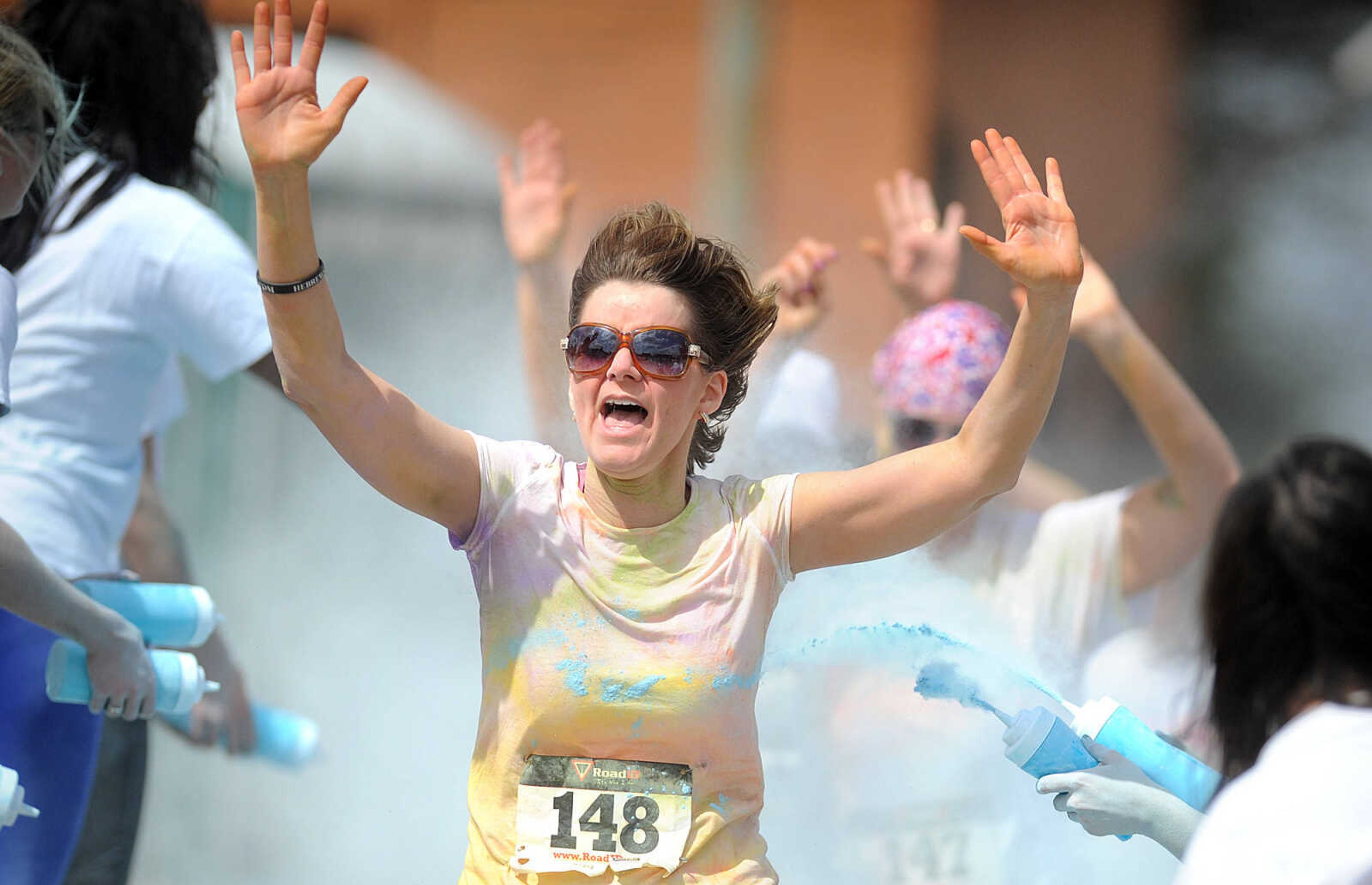 LAURA SIMON ~ lsimon@semissourian.com

Participants in the Color Me Cape 5K are sprayed with blue powder at the final color station on Main Street, Saturday, April 12, 2014, in Cape Girardeau.