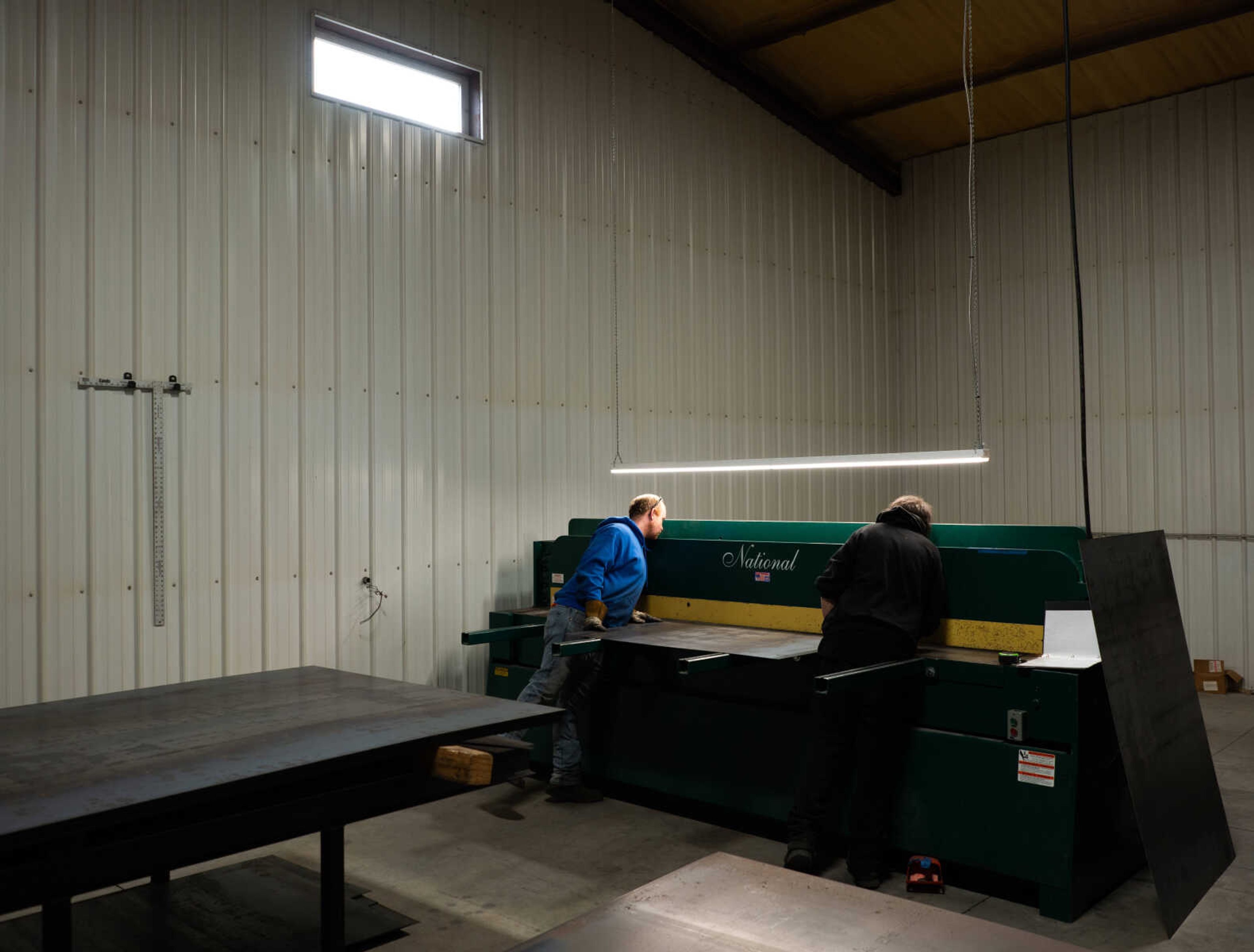 Employees at Ole Hickory Pits use a large press to cut heavy gauge sheets of metal. Ole Hickory Pits produces commercial, residential and competition smokers. 
