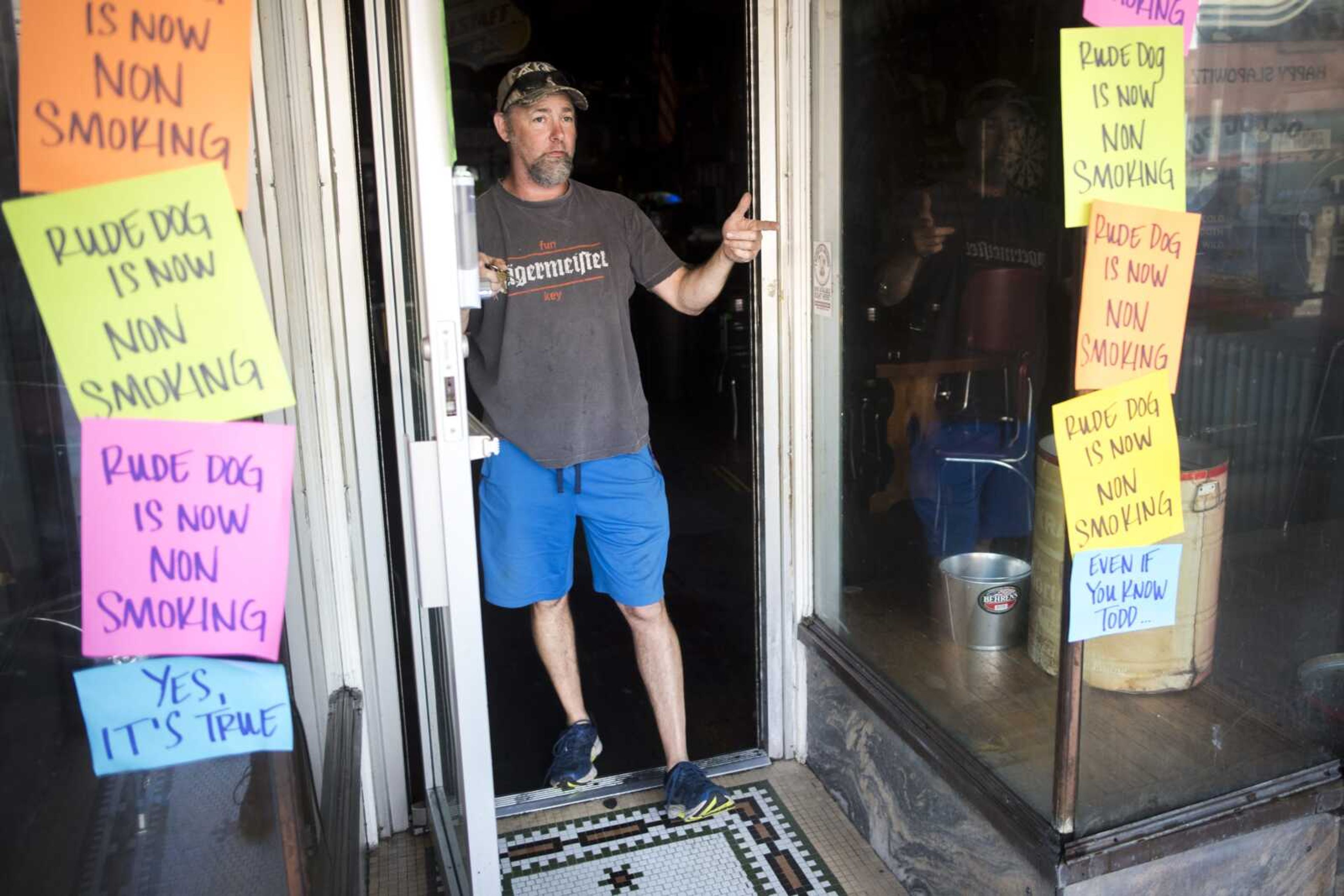 Rude Dog Pub co-owner Mark Weber explains plans to remodel the bar's existing entryway and construct an outdoor smoking area at his business Wednesday in Cape Girardeau. The bar recently announced it would no longer allow indoor smoking and is scheduled to re-open Sunday.