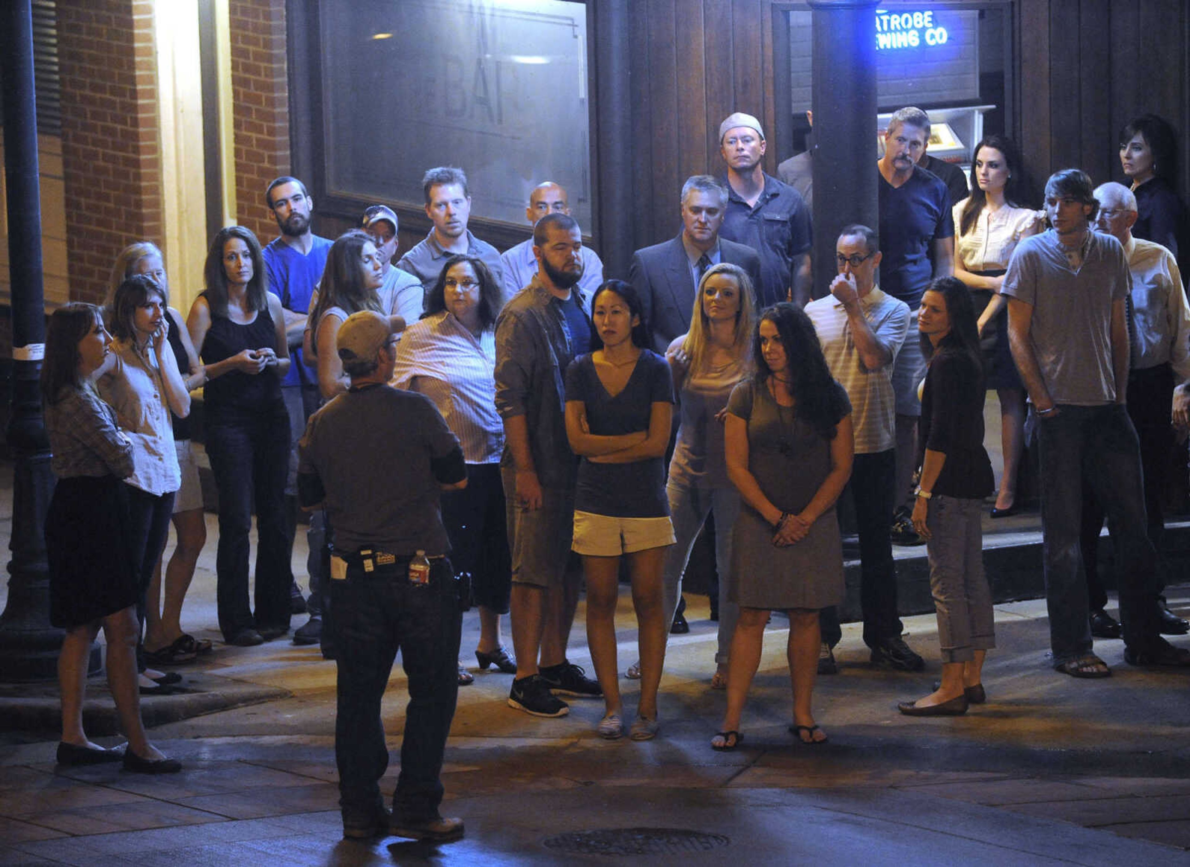 FRED LYNCH ~ flynch@semissourian.com
Extras for "Gone Girl" listen to directions outside The Bar Friday, Sept. 27, 2013 in downtown Cape Girardeau.